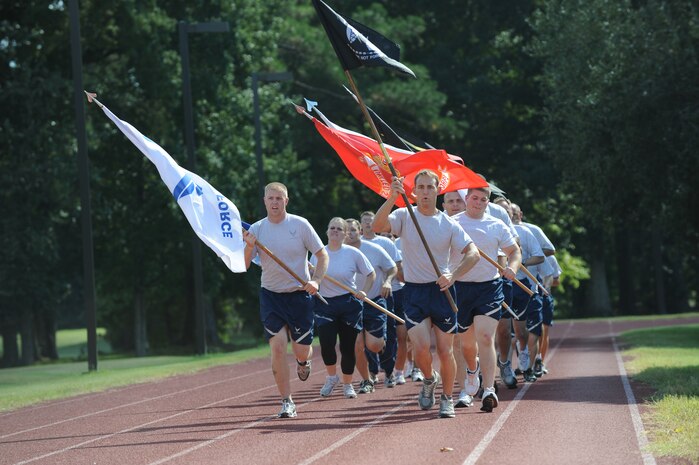 U.S. Air Force Staff Sgt. Chase Schexnayder leads the pack carrying the Prisoner of War/Missing in Action flag with fellow Airman Leadership School classmates close behind on Joint Base Charleston, S.C., Sept. 16, 2010. ALS students started the POW/MIA relay run, which spanned 24 hours. There were 42 teams in all who supported the run to keep the flag in continuous motion. Sergeant Schexnayder is an air transportation craftsman with the 437th Aerial Port Squadron. (U.S. Air Force photo/James M. Bowman)(Released)