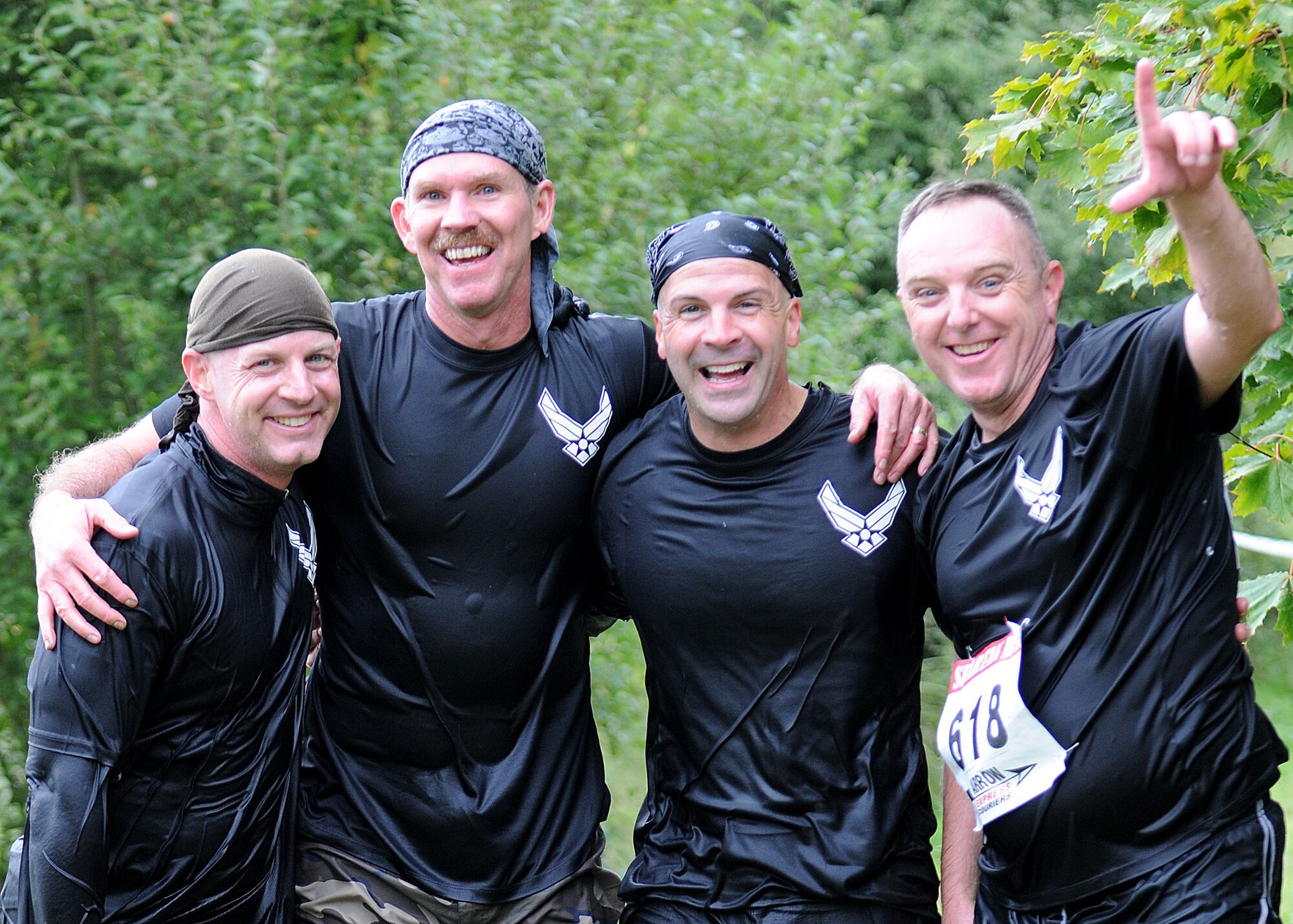 CAMBRIDGE, England -- Col. Joseph DeMarco, 100th Operations Group commander, Chief Master Sgt. Christopher Powell, 100th Air Refueling Wing command chief, Col. Chad Manske, 100th Air Refueling Wing commander, and Lt. Col. Don Robertson, 100th Security Forces Squadron commander, pose for a quick group photo after enduring the water obstacle during the Spartan Race here Sept. 19. Participants pushed through 12 obstacles to complete the event. (U.S. Air Force photo/Staff Sgt. Jerry Fleshman)