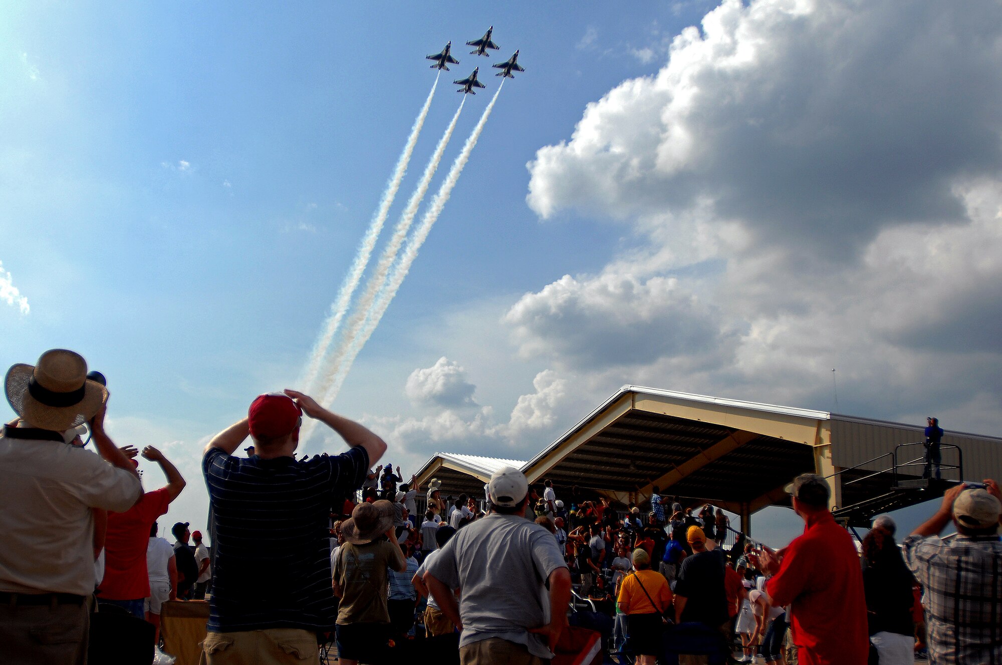 Whiteman Air Force Base, Mo. -- The U.S. Air Force Thunderbirds streak over the crowd at the 2010 Wings Over Whiteman Air Show and Open House, Sept. 18.  The U.S. Air Force Thunderbirds performed twice for spectators in attendance. Several different types of military and civilian aircraft were on display during the two-day event for all in attendance to see to include the Thunderbirds and the U.S. Army Golden Knights. More than 75,000 people attended the event. (U.S. Air Force photo by Senior Airman Kenny Holston) (Released)
