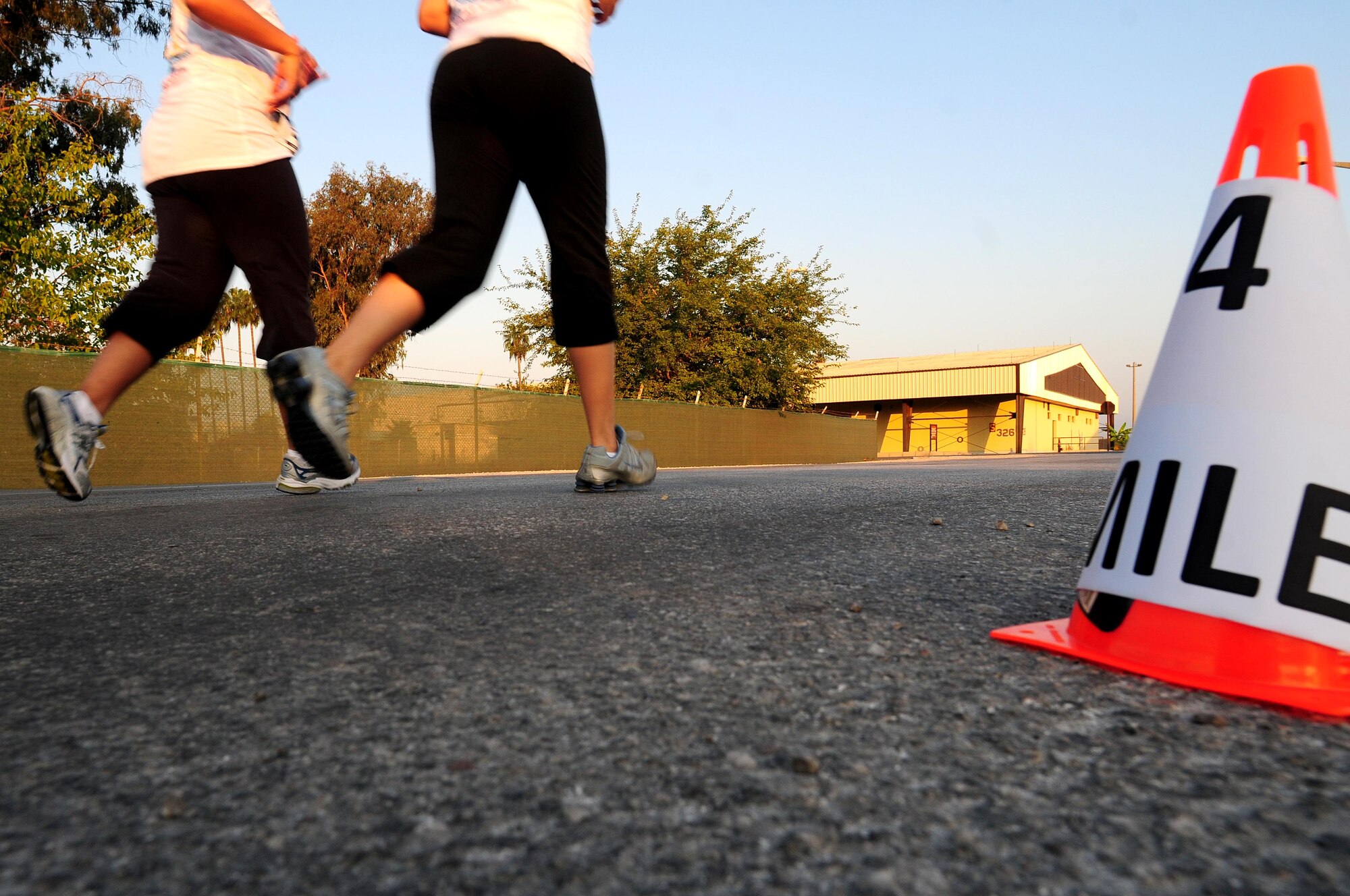 Two runners pass the 4 mile marker during the 4th annual Incirlik Half Marathon Sept. 18, 2010.  The marathon was hosted by the 39th Force Support Squadron and the fitness center on the same day as the 14th annual United States Air Force Marathon at Wright-Patterson Air Force Base, Ohio.  (U.S. Air Force photo by Senior Airman Ashley Wood/Released)
