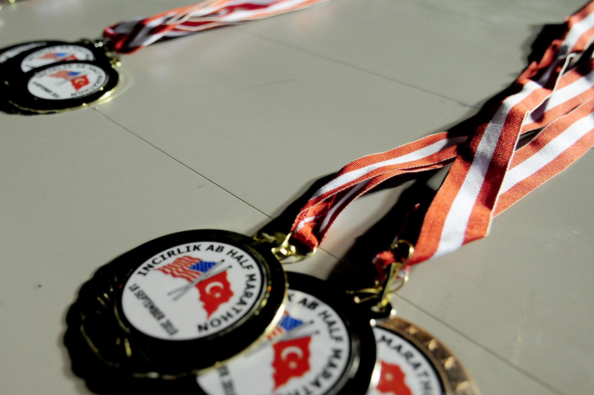 Medals are handed out to the top three runners in each category during the 4th annual Incirlik Half Marathon Sept. 18, 2010 at Incirlik Air Base, Turkey.  The categories during the marathon were males and females 29 and under, males and females 30 and over and teams.  The marathon was hosted by the 39th Force Support Squadron and the fitness center on the same day as the 14th annual United States Air Force Marathon at Wright-Patterson Air Force Base, Ohio.  (U.S. Air Force photo by Senior Airman Ashley Wood/Released)