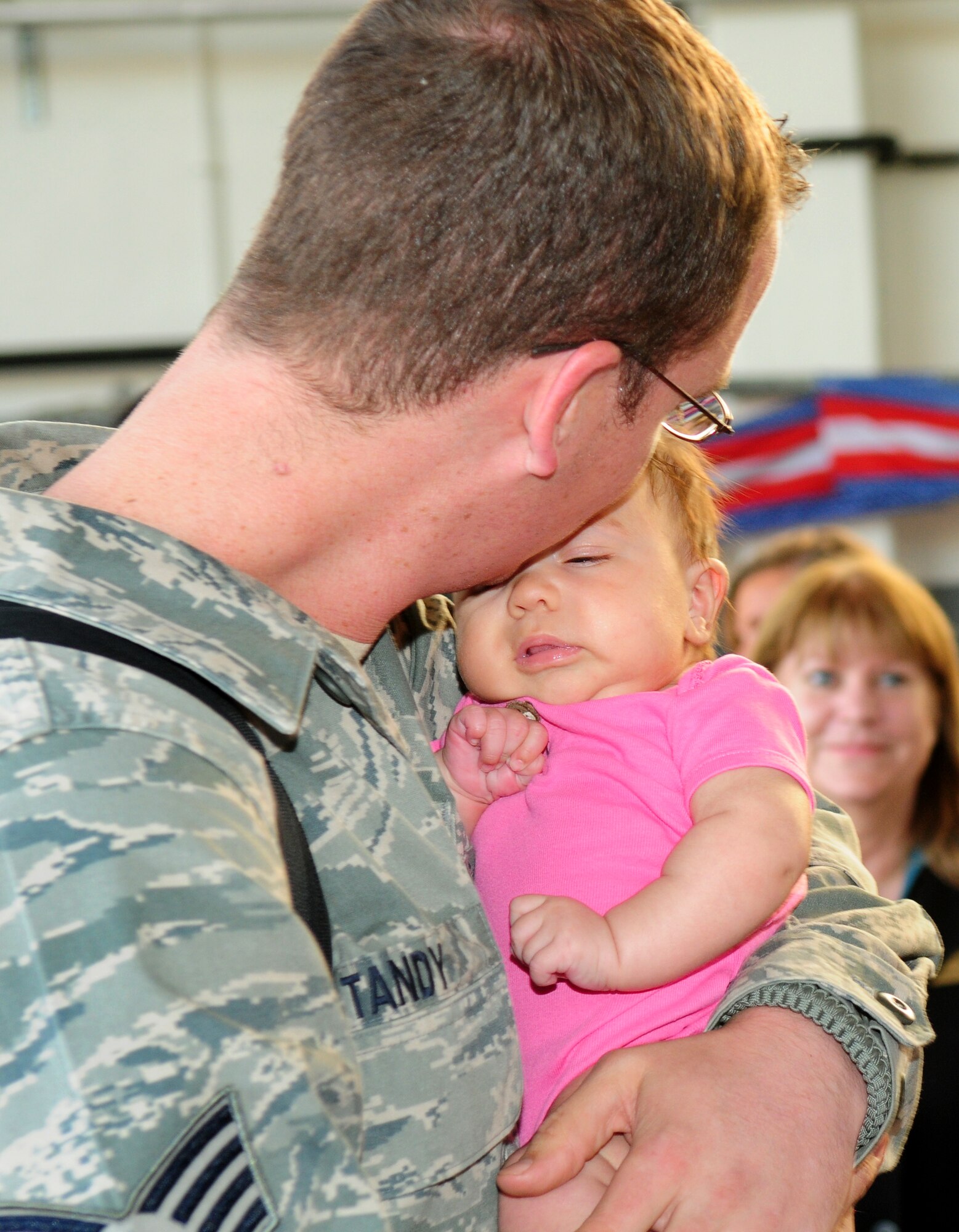 SPANGDAHLEM AIR BASE, Germany – Staff Sgt. Wesley Tandy, 52nd Aircraft Maintenance Squadron, kisses his newborn daughter, Ava, who was born during his deployment to Afghanistan.  Sergeant Tandy was deployed in support of the 81st Fighter Squadron. (U.S. Air Force photo/Staff Sgt. Heather M. Norris)