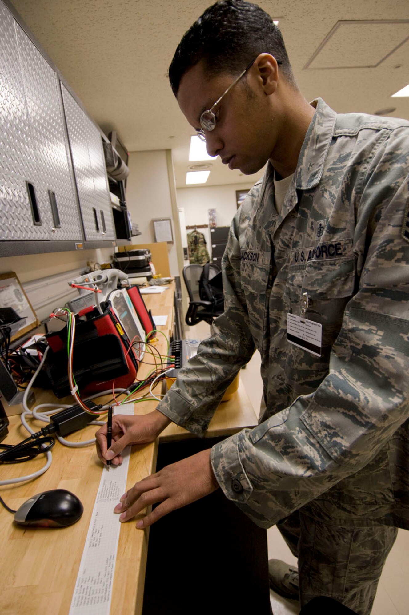 Staff Sgt. Hakan Jackson, 35th Medical Support Squadron biomedical equipment technician, completes an initial inspection of an automatic external defibrillator, Sept. 21, 2010, at the Misawa Air Base, Japan, hospital. The Whittier, Calif., native also provides repairs to this vital machine found base-wide, which emits an electric shock to a patient’s heart during a life-threatening arrhythmia. (U.S. Air Force photo by Senior Airman Jessica Lockoski/Released)