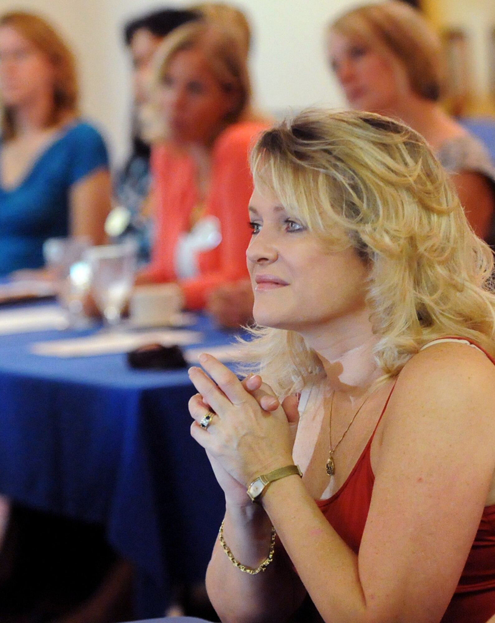 Susan St. Onge, wife of Lt. Col. Dave St. Onge from the 33rd Rescue Squadron, listens to a briefing during the quarterly leadership spouses forum at the Officers Club Sept. 20. More than 40 spouses Airmen in key positions around Kadena attended the conference to learn more about base resources and programs available to spouses within their respective units. (Air Force/Staff Sgt. Jason Lake)