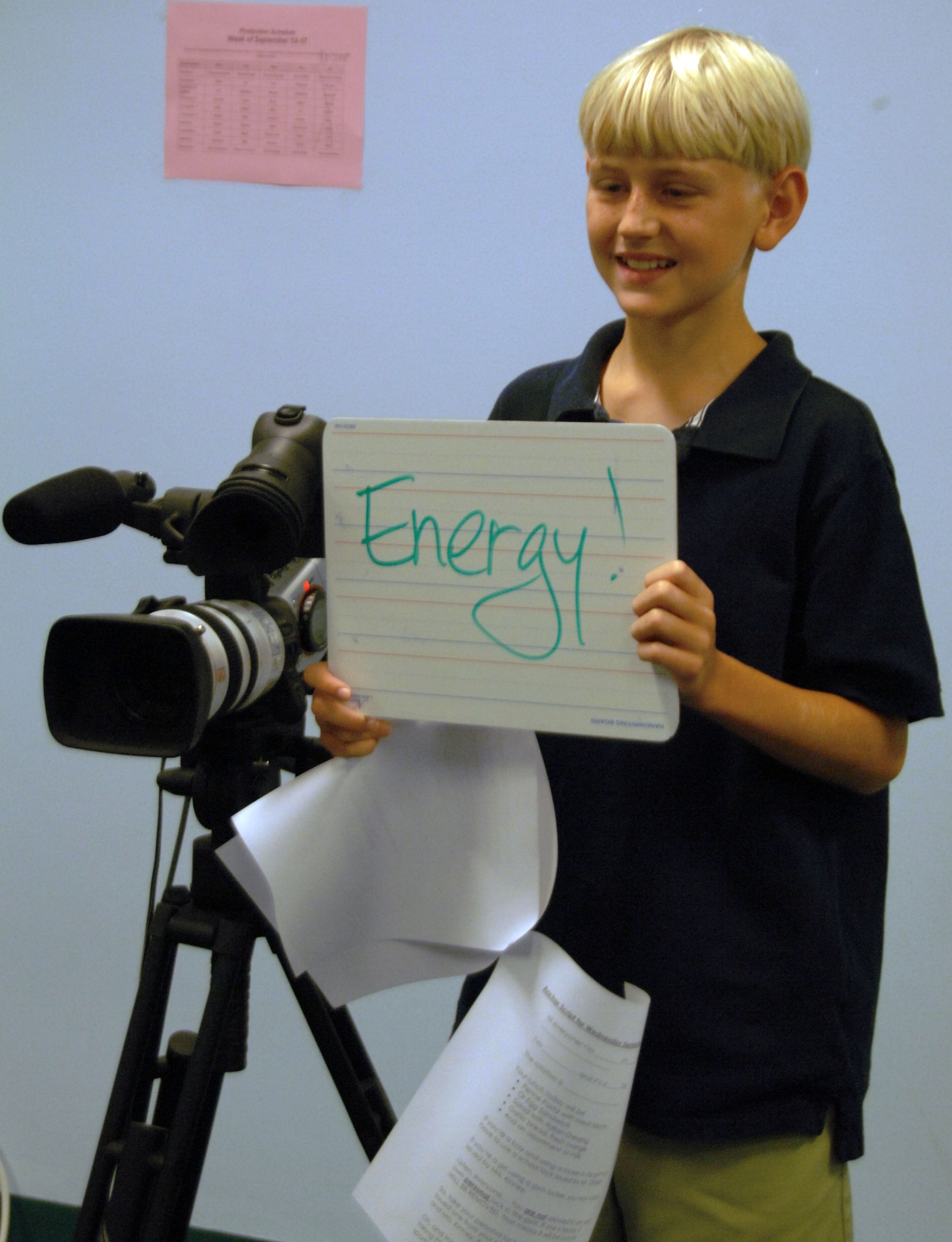 Arthur Hinsvark, an 8th grade student at Andersen Middle School, supervises filming and directs on-camera anchors during a KAMS-TV morning broadcast. The KAMS-TV crew is comprised of several students who work together to produce a show featuring news, sports and announcements that is broadcasted throughout the school. (U.S. Air Force photo by Airman Whitney Amstutz)