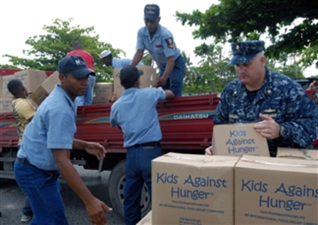 U.S. Navy Lt. Cmdr. Ken Cremeans (right), deputy mission commander for Southern Partnership Station 2010, helps members of the Dominican Republic's defense forces load pallets of Project Handclasp aid into trucks in Santo Domingo, Dominican Republic, on Sept. 20, 2010.  U.S. sailors and airmen embarked aboard the High Speed Vessel Swift (HSV 2) delivered educational, humanitarian and goodwill material to the country.  The ship also supported Southern Partnership Station 2010, a deployment of various specialty platforms to the U.S. Southern Command's area of responsibility in the Caribbean and Central America.  