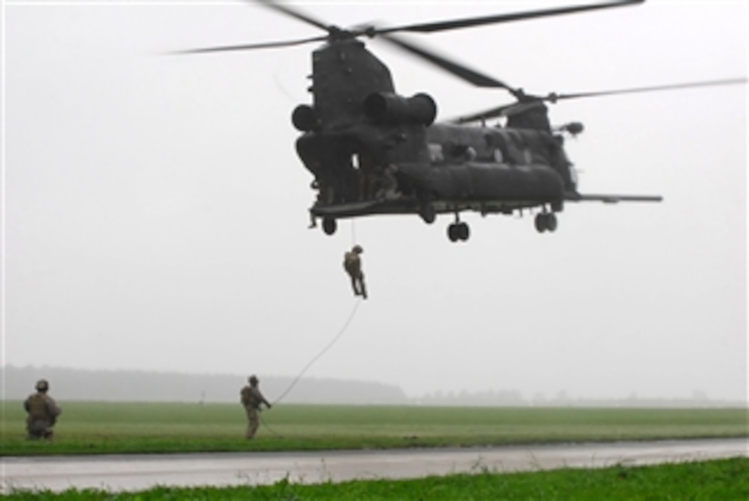 U.S. Air Force pararescuemen with the 321st Special Tactics Squadron fast-rope from a U.S. Army MH-47 Chinook helicopter during insertion training at Jackal Stone 10 at the 21st Tactical Airbase, Swidwin, Poland, on Sept. 14, 2010.  The international special operations forces exercise is held annually.  