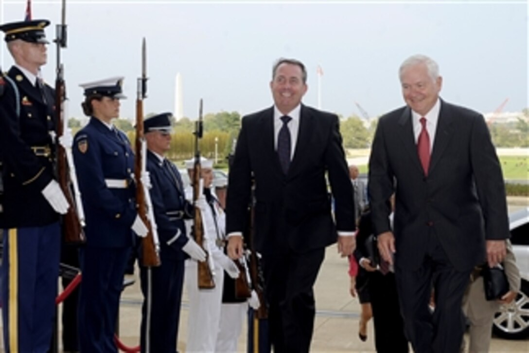 Secretary of Defense Robert M. Gates escorts British Defense Minister Liam Fox through an honor cordon and into the Pentagon on Sept. 22, 2010.  