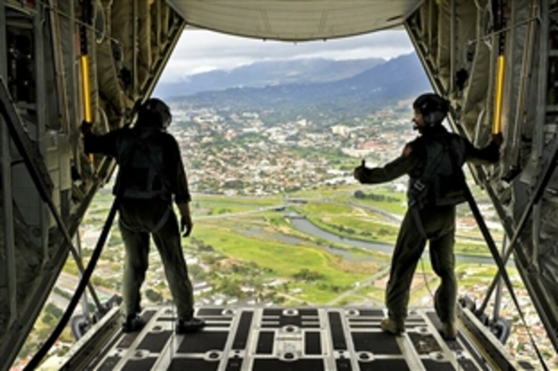 U.S. Air Force Master Sgts. Rich Baarda, left, and Kyle Grunon stand at the open back end of the C-130J aircraft during a validation flight for Africa Aerospace and Defense in Cape Town, South Africa, Sept. 20, 2010. Baarda and Grunon are assigned to the 143rd Airlift Wing, Rhode Island Air National Guard.