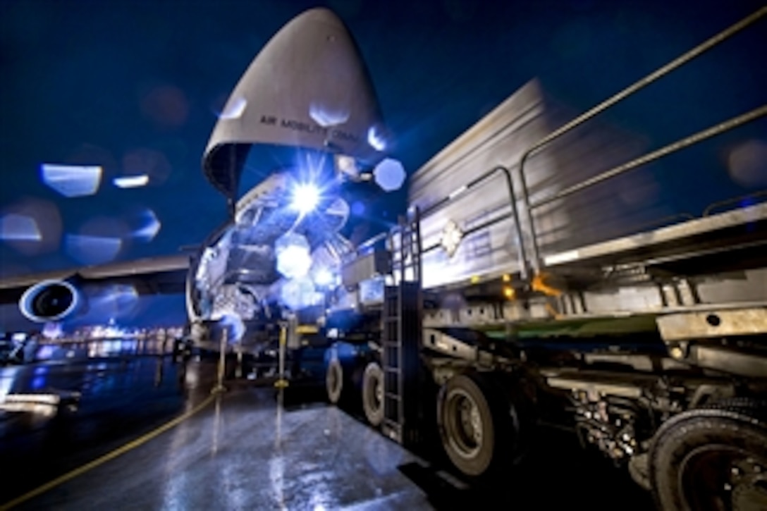 U.S. Air Force airmen move equipment pallets onto a C-5 Galaxy aircraft on Yokota Air Base, Japan, Sept. 15, 2010. The airmen are assigned to the 730th Air Mobility Squadron. 