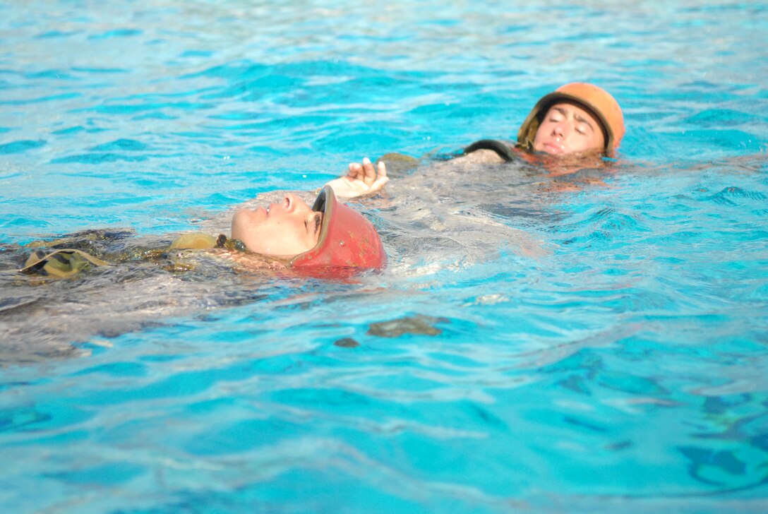 In an exercise demonstrating knowledge of life saving procedures, Lance Cpl. Aaron Chasse, infantryman, 2nd battalion, 1st Marines, right, buddy tows Cpl. Anthony Noble, infantryman, 1st Battalion, 5th Marines, during a Marine Combat Instructor of Water Survival course at Marine Corps Air Station Miramar, Calif., Sept.22.