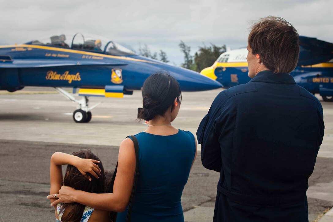 James Clarke, a physics teacher at Punahou School in Honolulu, waits with his family before his key influencer flight in one of the Blue Angels F/A-18 Hornet fighter jets at Marine Corps Air Station Kaneohe Bay, Hawaii, Sept. 22, 2010. Clarke was one of several local figures awarded the opportunity to fly in one of the Blue Angels. The famed Blue Angels, part of the U.S. Navy’s Flight Demonstration Squadron, are slated to perform during the Kaneohe Bay Airshow here Sept. 25 to 26.