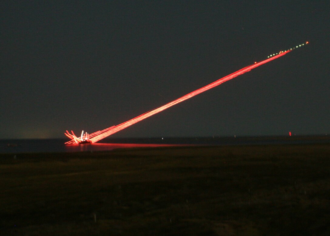 A Super Cobra Attack Helicopter opens fire during a training exercise at Piney Island, N.C., in support of 2nd Air-Naval Gunfire Liaison Company, II Marine Expeditionary Force Headquarters Group, Sept. 22, 2010. Marines with 2nd ANGLICO coordinated with aircraft during the training, calling in attacks on targets, and later conducting an aerial resupply.