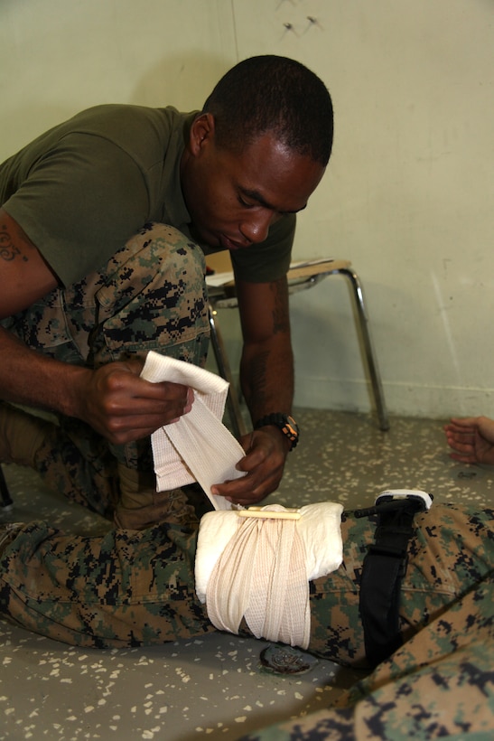 Sgt. Xavier W. Wethington, native of Brunswick, Ga., and air-traffic control specialist with Marine Air Control Squadron 2, applies a pressure-dressing to a simulated wounded casualty during practical application for Combat Life Saver training aboard the USS Iwo Jima, Sept. 23, 2010. Marines with MACS-2, Command Element of Special-Purpose Marine Air-Ground Task Force Continuing Promise 2010 participated in the five-day training while operating off the coast of Bluefields, Nicaragua, during their four-month deployment to the Caribbean, Central and South America.