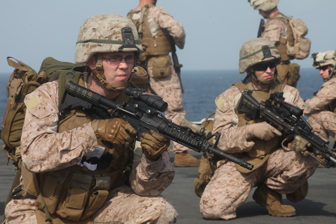 Seaman Chadwick Bookout, a corpsman with Weapons Company, Battalion Landing Team 3/8, 26th Marine Expeditionary Unit, provides security during a Tactical Recovery of Aircraft and Personnel (TRAP) exercise on the flight deck of USS Kearsarge in the U.S. Navy Fifth Fleet Area of Operation, Sept. 23, 2010.  26th Marine Expeditionary Unit deployed aboard the ships of Kearsarge Amphibious Ready Group in late August responding to an order by the Secretary of Defense to support Pakistan flood relief efforts.