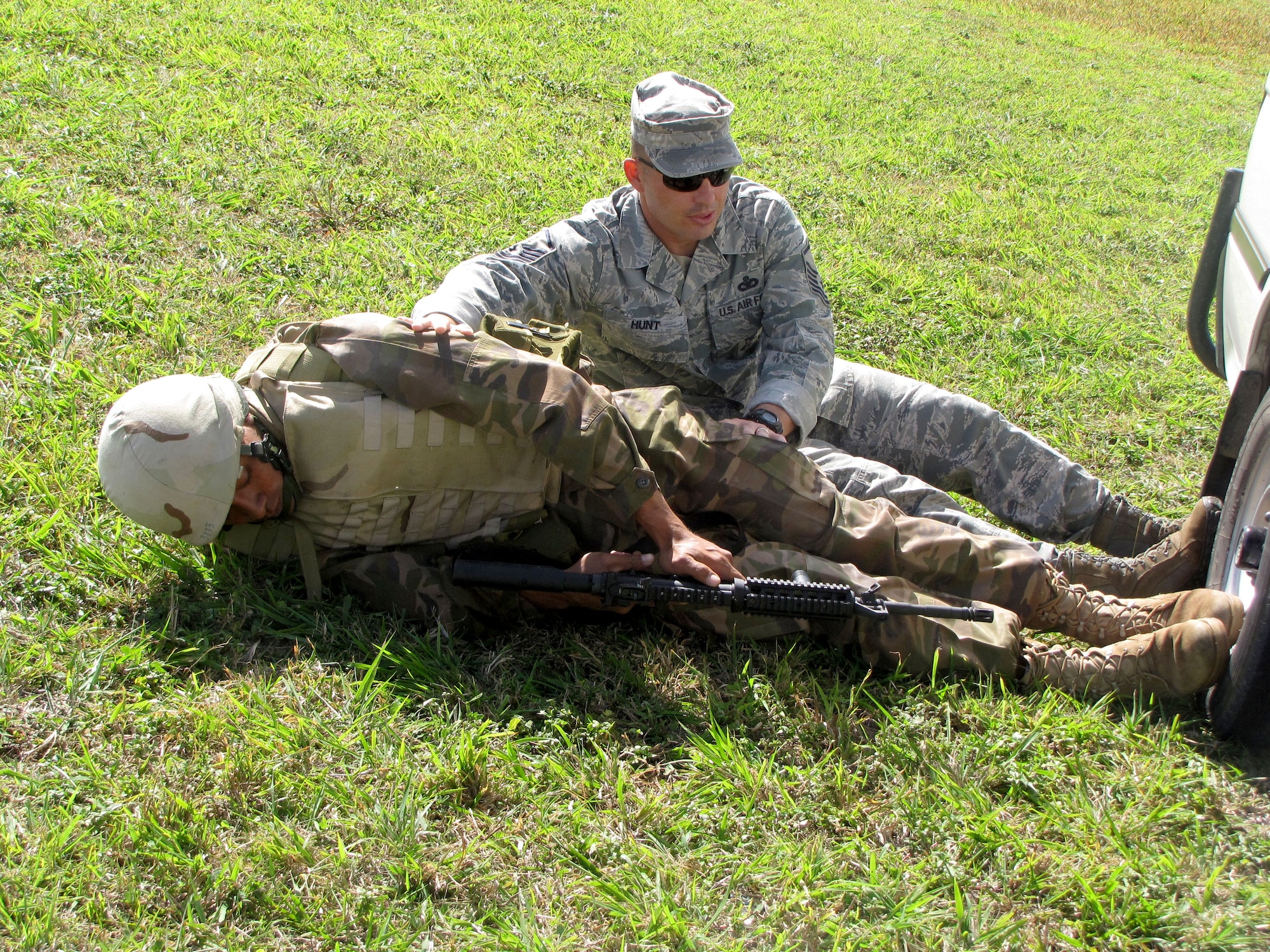 Master Sgt. Richard Hunt, a cadre instructor from the 736th Security Forces Squadron’s Commando Warrior Regional Training Center at Andersen Air Force, Guam,  and  a Tongan military security forces member practice movement-under simulated tactical fire during a U.S. and Tongan Subject-Matter Expert Exchange in Nuku’alofa, Kingdom of Tonga,  on Sept. 15, 2010.   The SMEE, which focused on tactical-team combat maneuvers, allowed U.S. and Tongan forces to share force protection and security operations information and understanding among attendees.  (U.S. Air Force photo/ Francis Deniz) 
