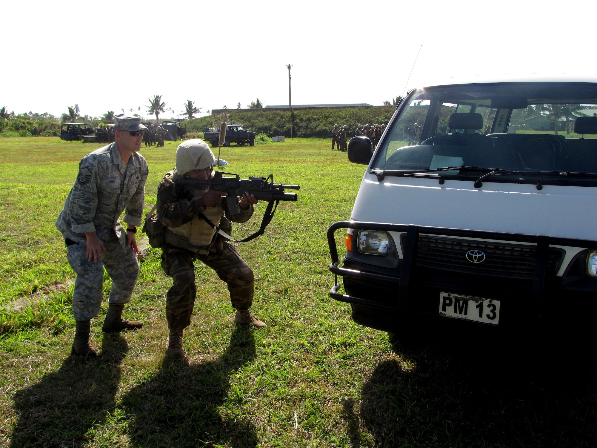 Master Sgt.  Richard Hunt, a cadre instructor from the 736th Security Forces Squadron’s Commando Warrior Regional Training Center at Andersen Air Force, Guam, demonstrates tactical-firing around a vehicle techniques to Tongan military security force members during a U.S. and Tongan Subject-Matter Expert Exchange in Nuku’alofa, Kingdom of Tonga, on Sept. 13, 2010.   The SMEE, which focused on tactical-team combat maneuvers, allowed U.S. and Tongan forces to share force protection and security operations information and understanding among attendees. (U.S. Air Force photo/ Francis Deniz) 