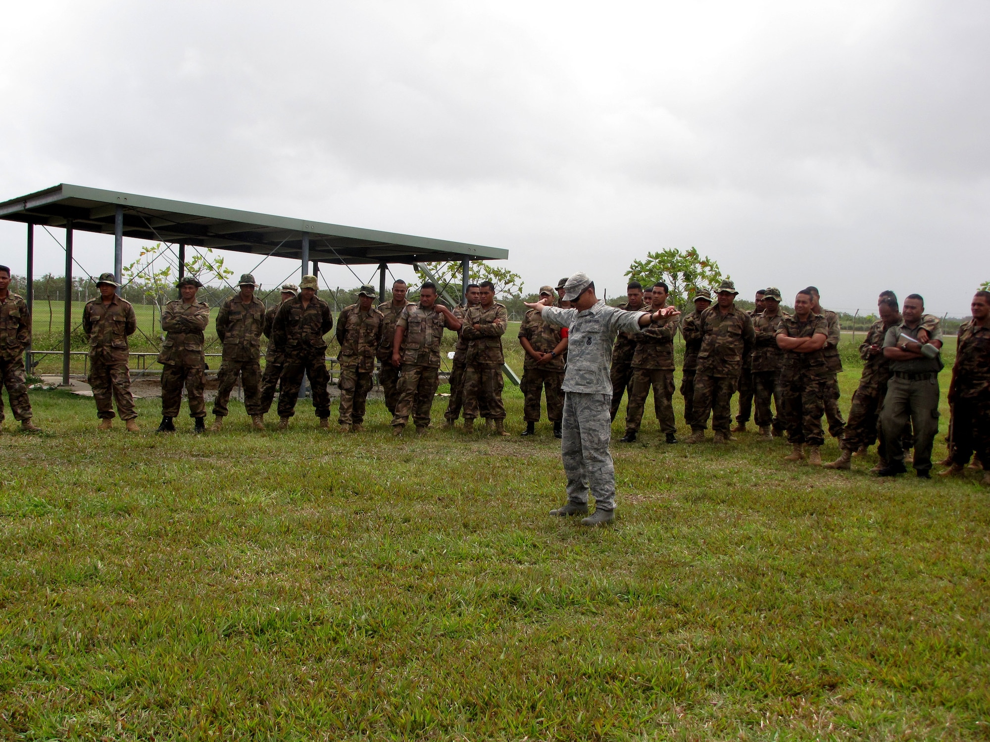 Tech. Sgt.  Darryle Mansnayon, a cadre instructor from the 736th Security Forces Squadron’s Commando Warrior Regional Training Center at Andersen Air Force, Guam, demonstrates enemy prisoner of war search and rescue techniques with Tongan security forces during a U.S. and Tongan Subject-Matter Expert Exchange in Nuku’alofa, Kingdom of Tonga, on Sept. 13, 2010.  The SMEE, which focused on tactical-team combat maneuvers, allowed U.S. and Tongan forces to share force protection and security operations information and understanding among attendees. (U.S. Air Force photo/ Francis Deniz) 