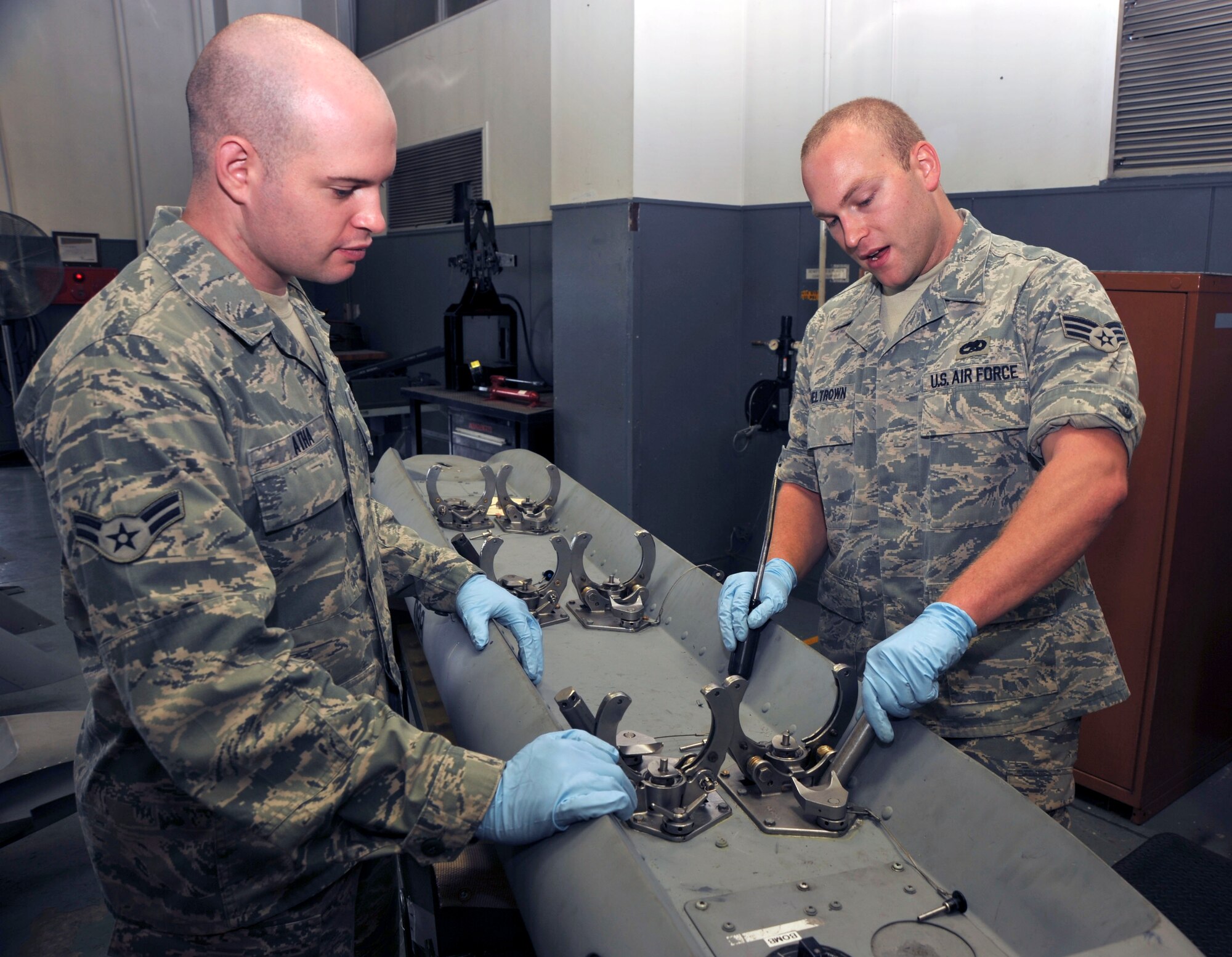 U.S. Air Force Senior Airman Dan Sheltrown, right, 35th Maintenance Squadron Weapons Armament Flight, trains Airman 1st Class Jeff Atha, left, 35 MXS/MXMR  on how to inspect  a bomb dispenser at Misawa Air Base, Japan, Sept. 21, 2010. (U.S. Air Force photo by Tech. Sgt. Russell McBride/Released)

