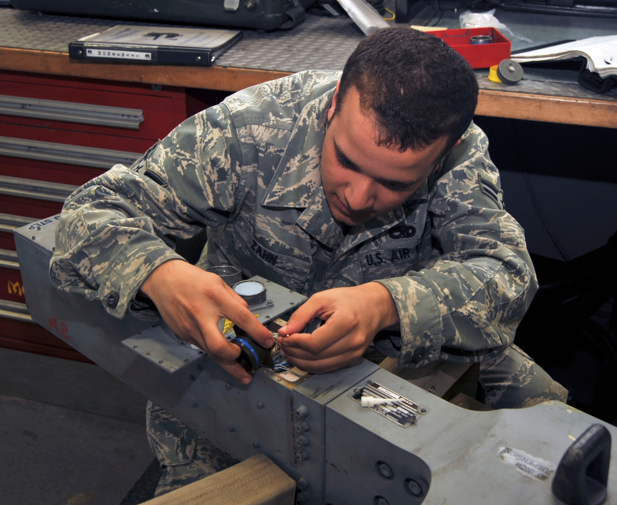A close look at U.S. Air Force Airman from the, 35th Maintenance Squadron Weapons Armament Flight, repins a video connector on a launcher air unit for the F-16 Fighting Falcon at Misawa Air Base, Japan, Sept. 21, 2010. (U.S. Air Force photo by Tech. Sgt. Russell McBride/Released)