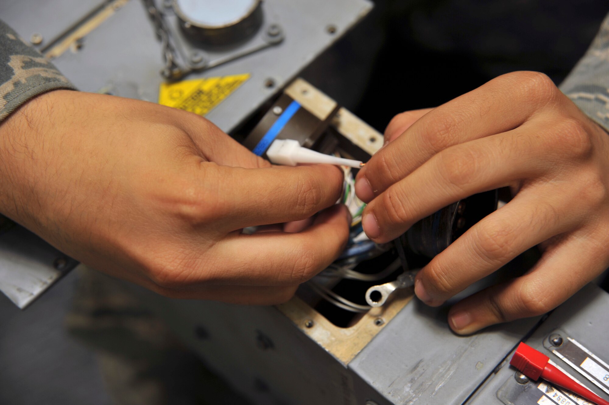 U.S. Air Force Airman 1st Class Joshoah Zahn, 35th Maintenance Squadron Weapons Armament Flight, repairs a broken video connector on a launcher air unit for the F-16 Fighting Falcon at Misawa Air Base, Japan, Sept. 21, 2010. The 35th MXS/MXMR provides safe, reliable equipment and munitions to train. F-16 Fighting Falcon pilots. (U.S. Air Force photo by Tech. Sgt. Russell McBride/Released)