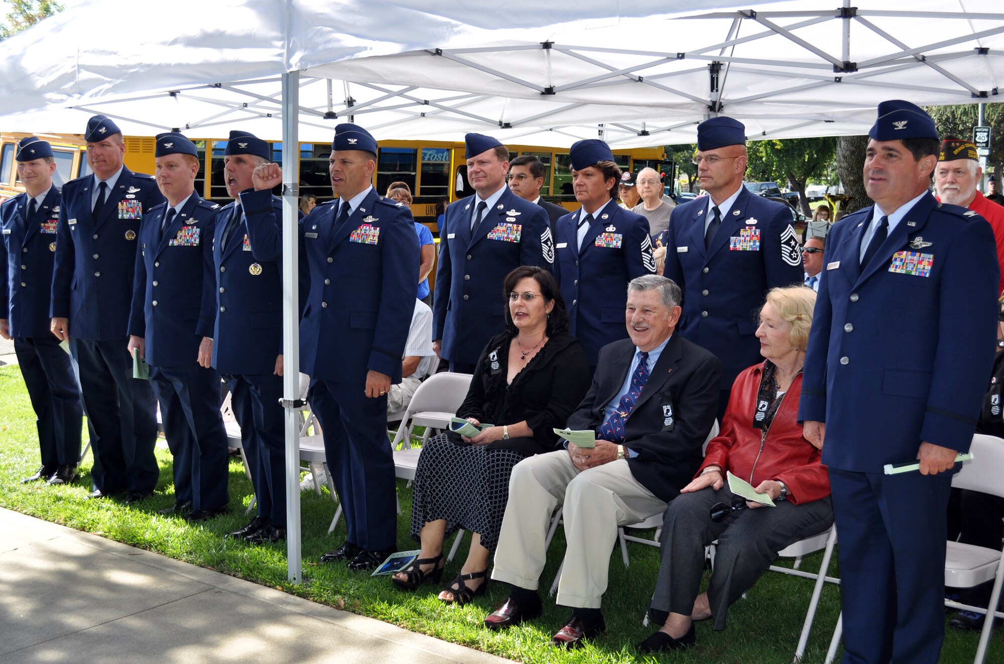 TRAVIS AIR FORCE BASE, Calif. -- Sept. 11, 2010, began a week of activities as Travis AFB kicked off "Team Travis Salutes Solano County." Part of that was the annual observance of National POW/MIA Day Sept. 17. Pictured here, the commanders led a large contingent of Airmen in a rousing rendition of the Air Force Song at the close of the Vacaville POW/MIA Recognition Ceremony. From the left: Brig. Gen. Robert Thomas, 15th Expeditionary Mobility Task Force commander, Col. John Lipinski, 15th EMTF vice commander, Col. Michael Keenan, individual mobilization augmentee to the 15th EMTF commander; Col. Jay Flournoy, 349th Air Mobility Wing commander, Col. Jim Vechery, 60th AMW commander, Chief Master Sgt. Michael LaPlant, 615th Contingency Response Wing command chief, CMSgt. Kathleen Buckner, 349th AMW command chief, CMSgt. Daniel Fischer, 60th AMW command chief, and Col. Barrett Broussard, 349th AMW vice commander. (U.S. Air Force photo/Senior Master Sgt. Ellen L. Hatfield)