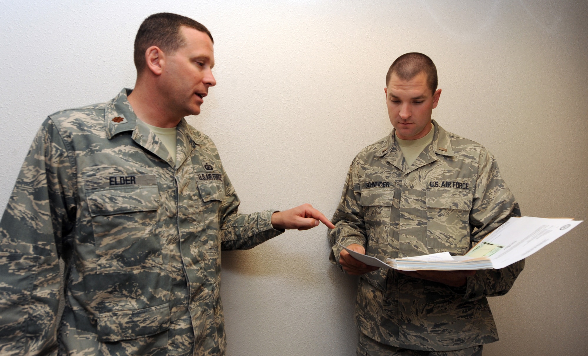 MOUNTAIN HOME AIR FORCE BASE, Idaho -- Major Mitchell Elder, 366th Contracting Squadron commander, answers questions for 2nd Lt. Justin Schneider, 366th Contracting Squadron officer in charge of services and commodities, regarding a contract for end of year Sept 10. The Contracting Squadron optimizes mission execution by ensuring high quality, timely support, and that they are consistent with federal acquisition regulations and public law. (U.S. Air Force photo by Senior Airman Debbie Lockhart)