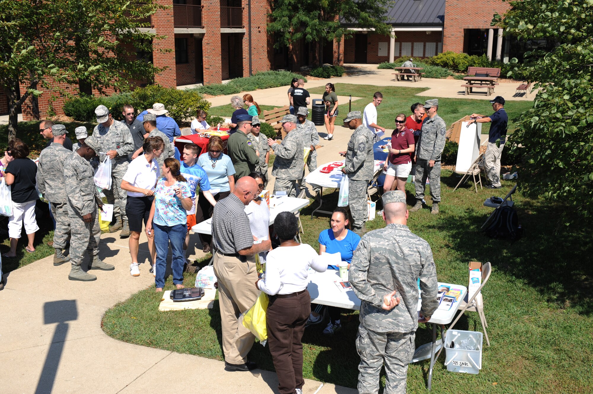 SCOTT AIR FORCE BASE, Ill. -- Team Scott members visit booths during the Suicide Prevention Field Day Sept. 23. Hosted by the Integrated Delivery System and highlighting Comprehensive Airman Fitness, the day focused on the ability of one person to save another’s life simply by being there. (U.S. Air Force photo/ Senior Airman Tristin English)