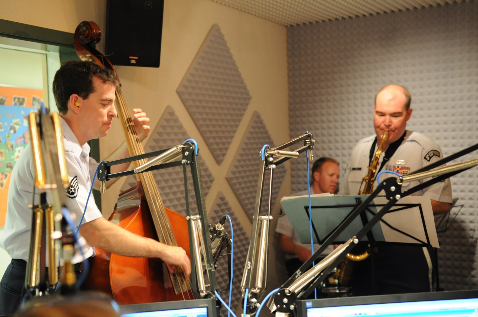 SSgt Leo Smith (bass), SSgt Mike Henrie (drums), and SSgt Jeff Hall (saxophone) perform during a live radio broadcast from Fairbanks, AK.  The Band of the Pacific's 'Dixie Express' were featured on KUAC radio's broadcast "Alaska Live", a program which features live in-studio performances of musicians touring in Alaska. (U.S. Air Force photo/Lisa Scerbak)