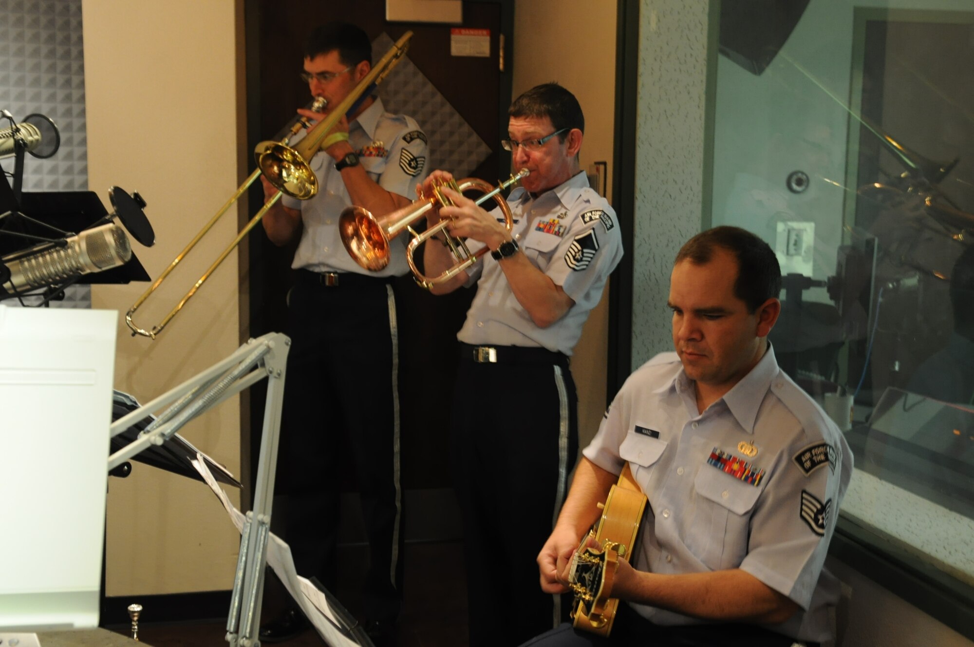 TSgt David McCormick (trombone), MSgt George Pierce (trumpet), and SSgt Ryan Manzi (guitar) perform during a live radio broadcast from Fairbanks, AK  The Band of the Pacific's 'Dixie Express' were featured on KUAC radio's broadcast "Alaska Live", a program which features live in-studio performances of musicians touring in Alaska. (U.S. Air Force photo/Lisa Scerbak)
