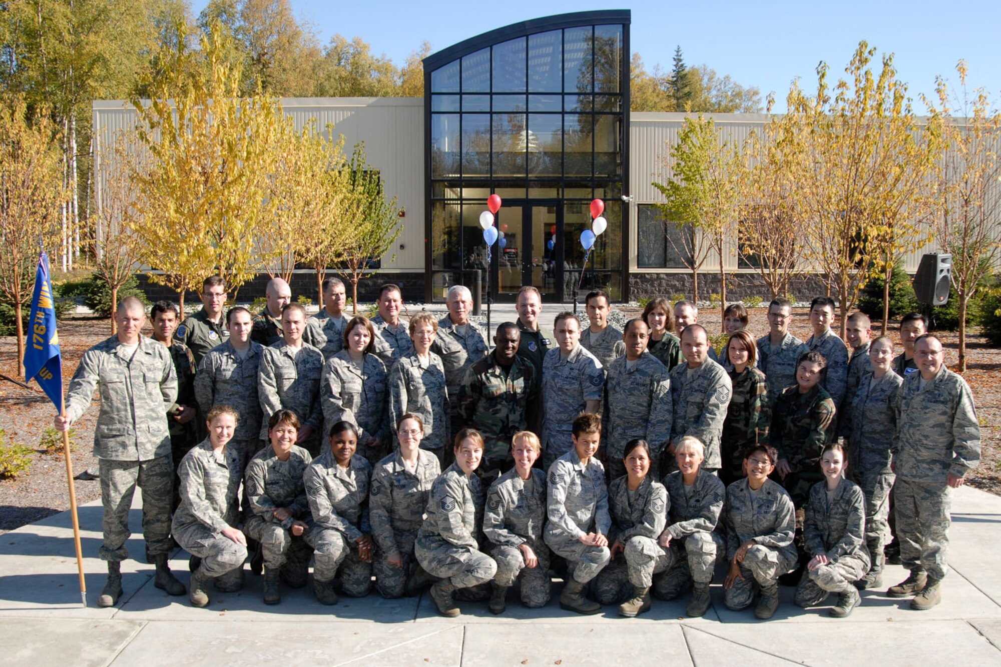 JOINT BASE ELMENDORF RICHARDSON, Alaska -- Members of the 176th Medical Group, Alaska Air National Guard, pose during the ribbon-cutting ceremony for their new Medical Readiness and Training Center here Sept. 19, 2010.  The Medical Group was one the first units from the 176th Wing to relocate here from Kulis Air National Guard Base. All wing units will eventually relocate here as part of the Federal 2005 Base Realignment and Closure (BRAC) legislation; most of the remaining units will make the move in early 2011. Alaska Air National Guard photo by Master Sgt. Shannon Oleson.