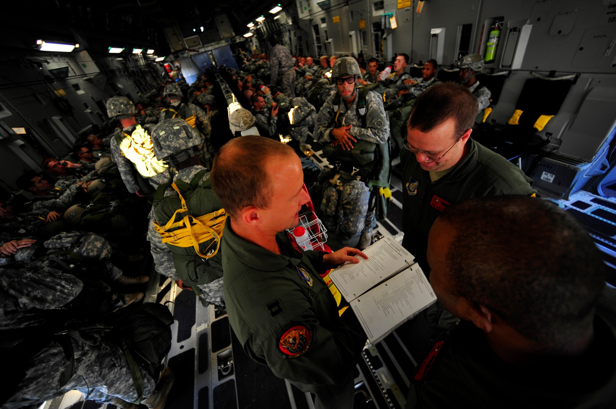 U.S. Air Force Globemaster III crew members, with the 535th Airlift Squadron from Hickam Air Force Base (AFB), H.I., review safety procedures prior to take off before a personnel drop during Joint Forcible Entry Exercise at Pope Air Force Base, N.C., Sept. 14, 2010. Joint Forcible Entry Exercise is a training event held six times a year in order to enhance cohesiveness between the Air Force and Army by executing large scale heavy equipment and troop movement for real world contingencies. (U.S. Air Force photo/Staff Sgt. Angelita M. Lawrence)
