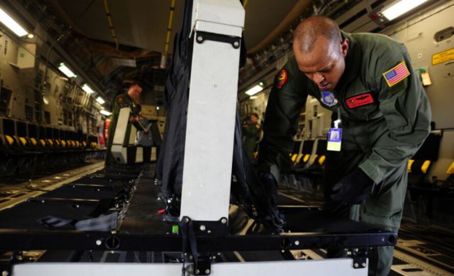 U.S. Air Force C-17 Globemaster III Loadmasters Tech. Sgt. Ike Murray and Staff Sgt. Lucas Crumpton with the 535th Airlift Squadron from Hickam Air Force Base (AFB), H.I., setup seats before Army Soldiers perform an airborne insertion during Joint Forcible Entry Exercise at Pope Air Force Base, N.C., Sept. 14, 2010.  Joint Forcible Entry Exercise is a training event held six times a year in order to enhance cohesiveness between the Air Force and Army by executing large scale heavy equipment and troop movement for real world contingencies. (U.S. Air Force photo/Staff Sgt. Angelita M. Lawrence)