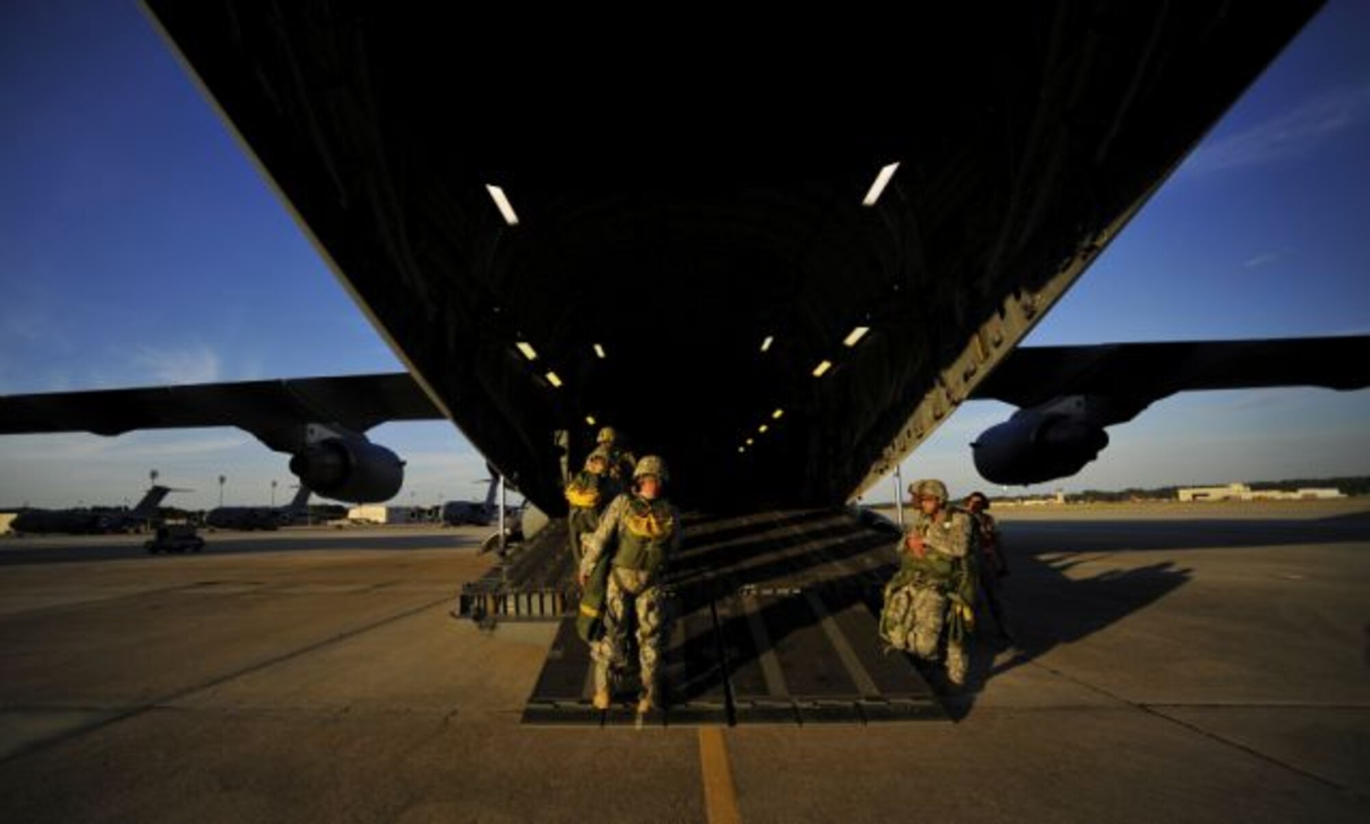 U.S. Army Soldiers assigned to the 82nd Airborne Division walks out to a C-17 Globemaster III prior to a parachute drop during Joint Forcible Entry Exercise at Pope Air Force Base, N.C., Sept. 14, 2010. Joint Forcible Entry Exercise is a training event held six times a year in order to enhance cohesiveness between the Air Force and Army by executing large scale heavy equipment and troop movement for real world contingencies. (U.S. Air Force photo/Staff Sgt. Angelita M. Lawrence)