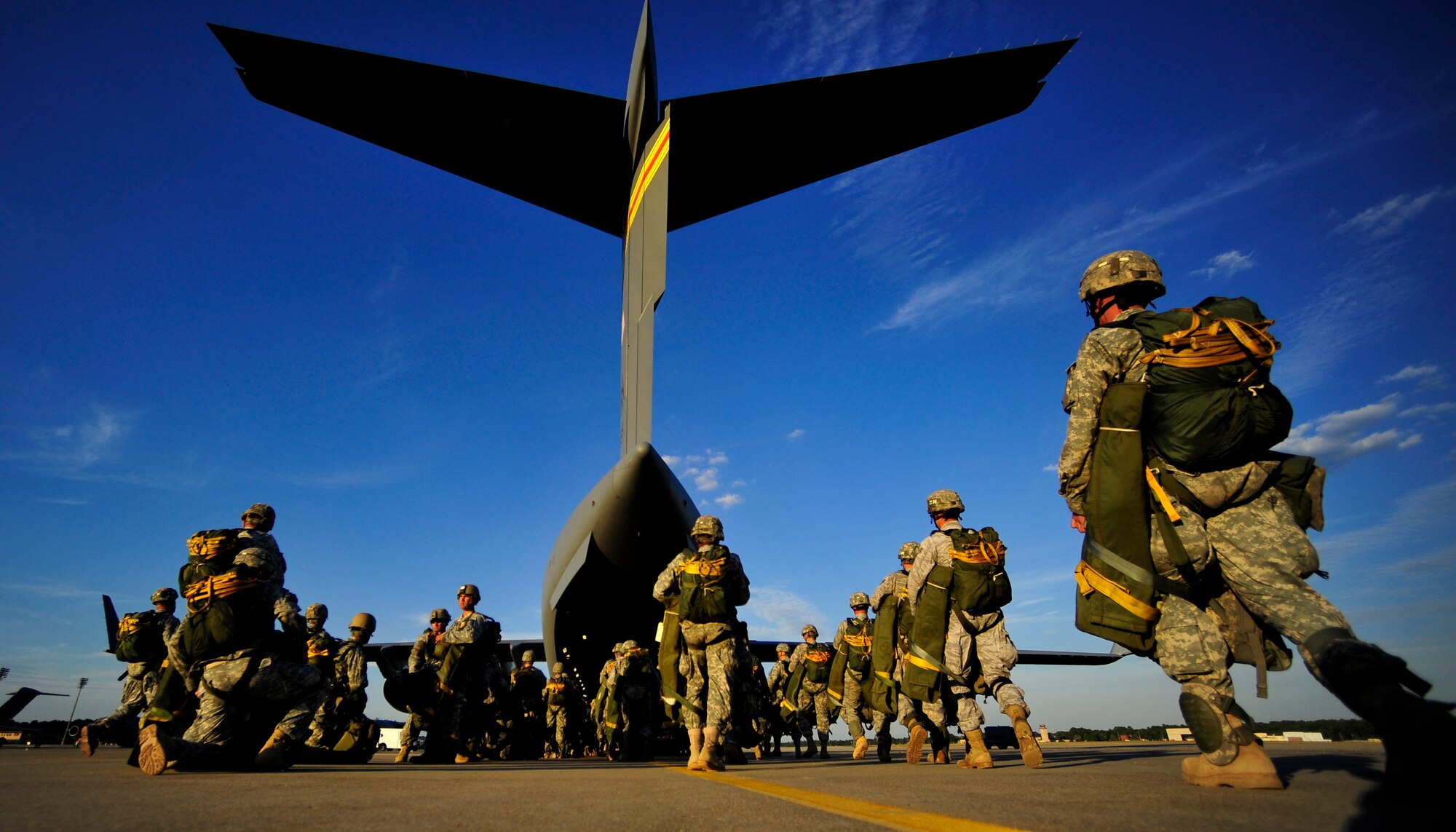 U.S. Army Soldiers assigned to the 82nd Airborne Division walks out to a C-17 Globemaster III prior to a parachute drop during Joint Forcible Entry Exercise at Pope Air Force Base, N.C., Sept. 14, 2010. Joint Forcible Entry Exercise is a training event held six times a year in order to enhance cohesiveness between the Air Force and Army by executing large scale heavy equipment and troop movement for real world contingencies. (U.S. Air Force photo/Staff Sgt. Angelita M. Lawrence)