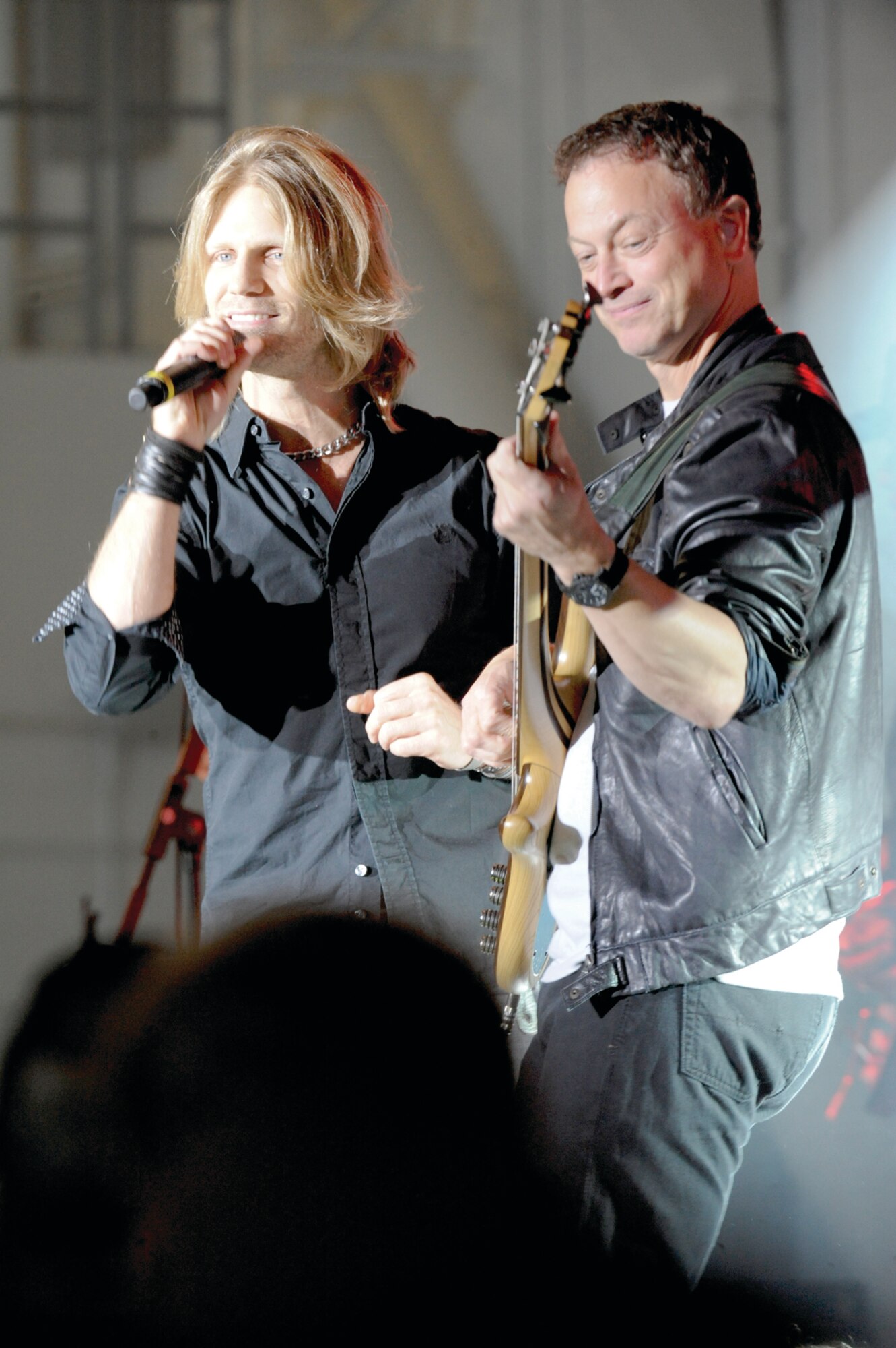 Vocalist Jeff Vezain and actor Gary Sinise, play cover songs for service members and families of Joint Base Elmendorf-Richardson, Sept. 16. Sinise plays the bass guitar for the Lieutenant Dan Band, which visits various military installations for performances to show appreciation for the armed services. (Photo by Air Force Staff Sgt. Joshua Garcia/JBER PAO)