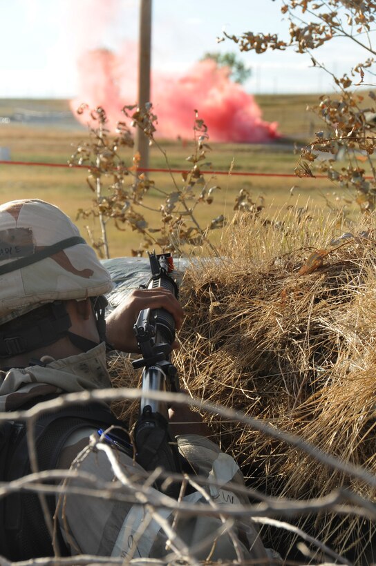 ELLSWORTH AIR FORCE BASE, S.D. -- Airman 1st Class Kenneth Gadid, 28th Civil Engineer Squadron heating, ventilation and air conditioning technician,  takes up a defensive position against a simulated ground attack during a Phase II Operational Readiness Exercise, Sept. 16.  Airmen are tested in the exercise with simulated attacks and scenarios. (U.S. Air Force photo/Airman 1st Class Anthony Sanchelli)

