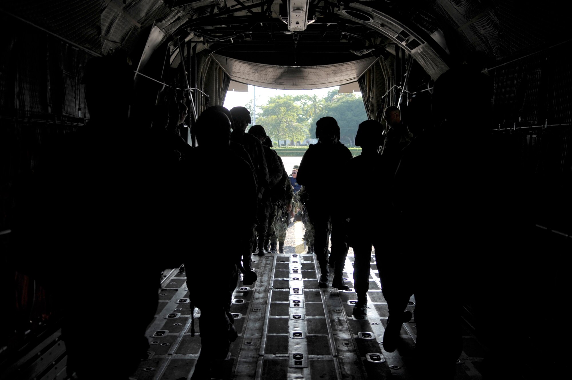 Colombian air force commandos run into the back of a C-130 Hercules during an exercise Sept. 16, 2010, at Palanquero Air Base, Colombia. The exercise was one of many during a weeklong subject matter expert exchange between Airmen from Moody's rescue community and Colombian air force C-130 crews here. (U.S. Air Force photo)