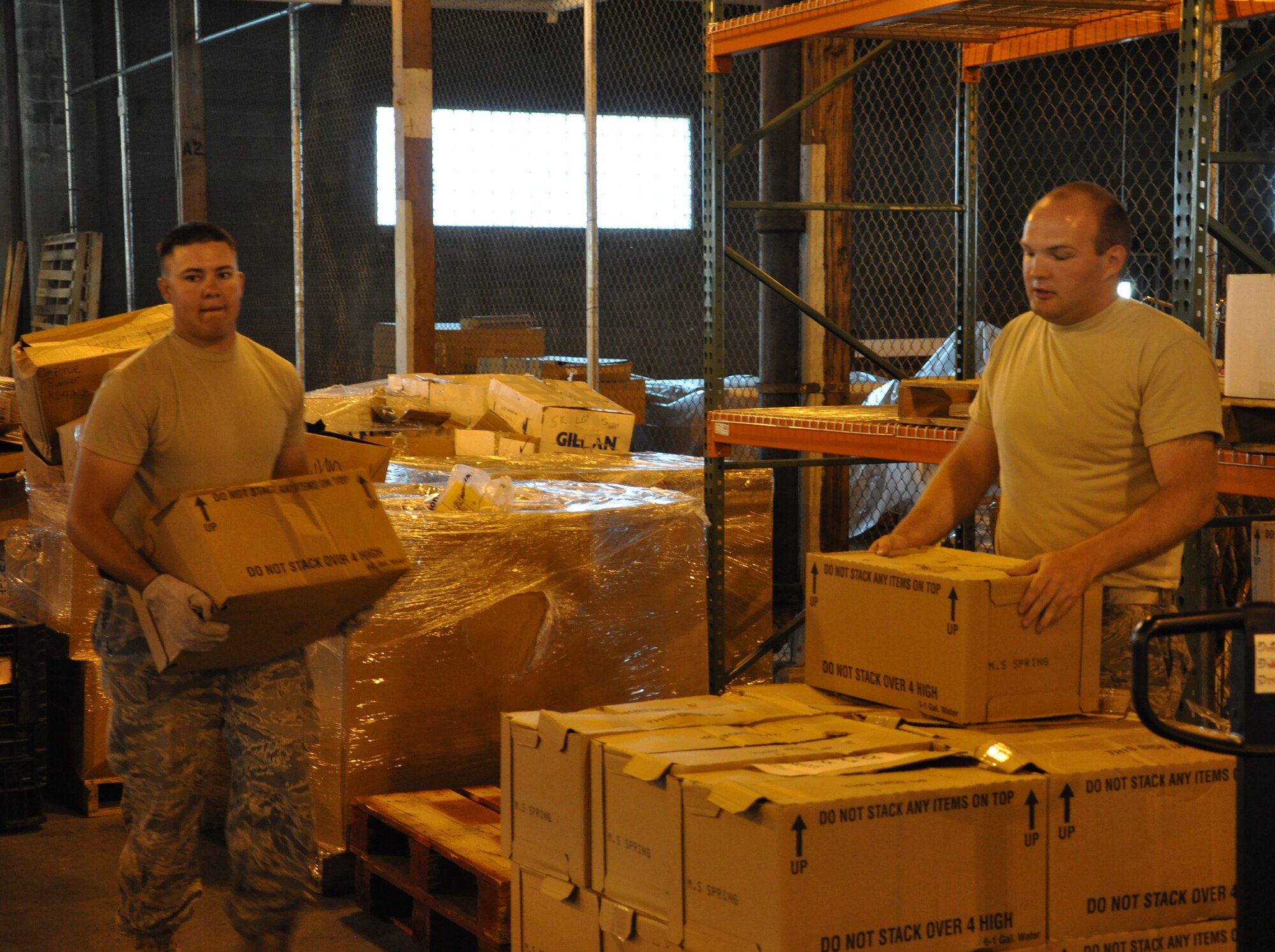 WRIGHT-PATTERSON AIR FORCE BASE, Ohio – From left to right, Staff Sergeants Joe Valenzuela, 445th Aeromedical Evacuation Squadron, and Jordan West, 87th Aerial Port Squadron, move boxes of left over items from the Air Force Marathon, which was held Sept. 18.  Some of the items will be used for next year’s marathon. (U.S. Air Force photo/Staff Sgt. Robert Nelson)