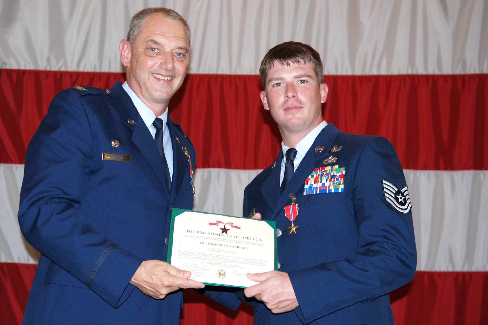 Technical Sgt. Jay Futrell, 917th Explosive Ordnance Disposal (EOD) Flight, poses for a photo with Col. John J. Mooney III, commander of the 917th Wing after being presented The Bronze Star Medal during award ceremonies in Hoban Hall at Barksdale Air Force Base, La., Sept. 12, 2010. Sergeant Futrell was awarded the medal for service while deployed to the 755th Bravo EOD Flight in Afghanistan from Sept. 30, 2009 to March 31, 2010. (U.S. Air Force photo/Master Sgt. Greg Steele)