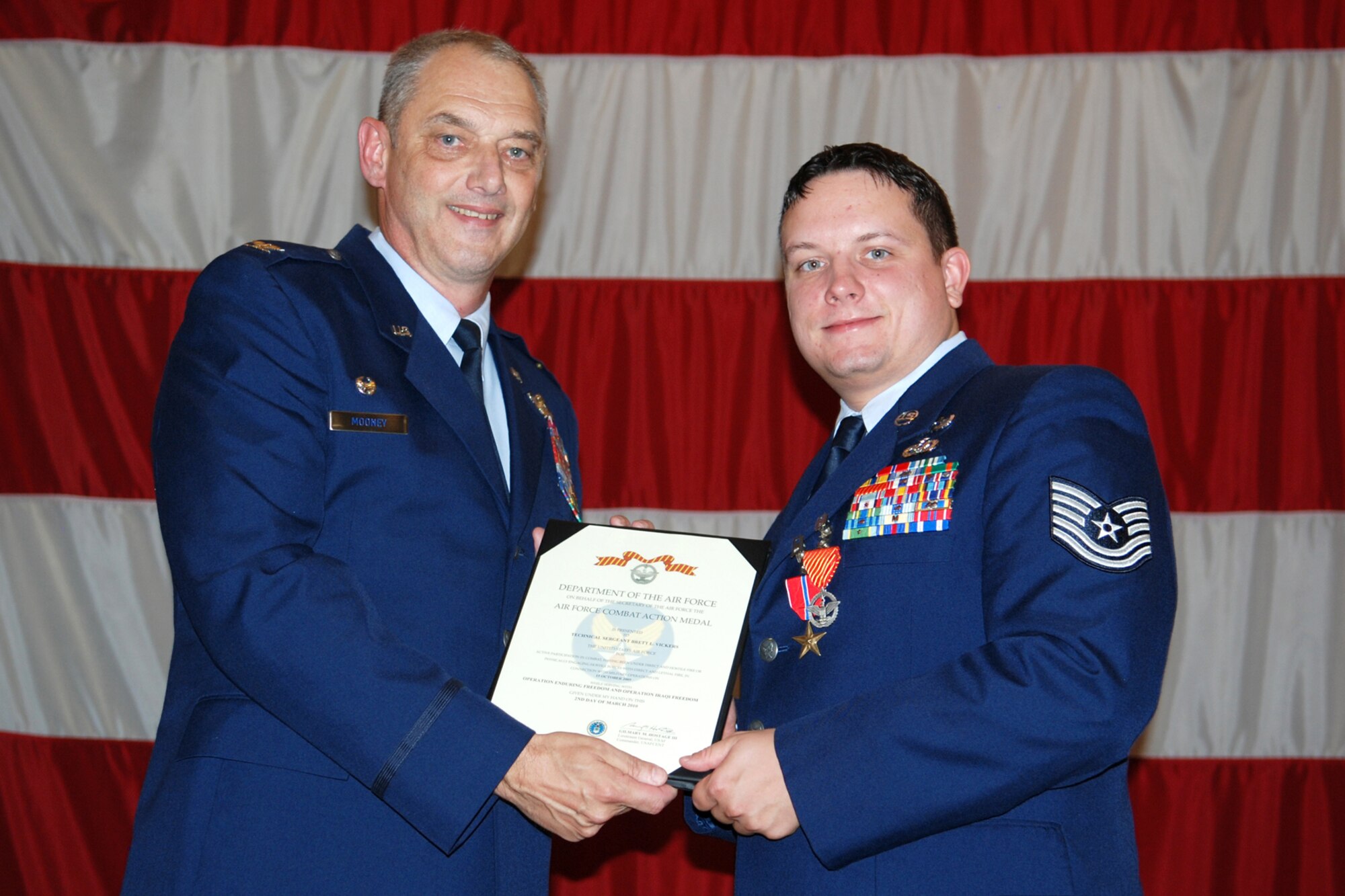Technical Sgt. Brett Vickers, 917th Explosive Ordnance Disposal (EOD) Flight, poses for a photo with Col. John J. Mooney III, commander of the 917th Wing after being presented The Bronze Star Medal and an Air Force Combat Action Medal during award ceremonies in Hoban Hall at Barksdale Air Force Base, La., Sept. 12, 2010. Sergeant Vickers was awarded the medals for service and actions while deployed to the 755th Bravo EOD Flight in Afghanistan from Sept. 30, 2009 to March 31, 2010. (U.S. Air Force photo/Master Sgt. Greg Steele)