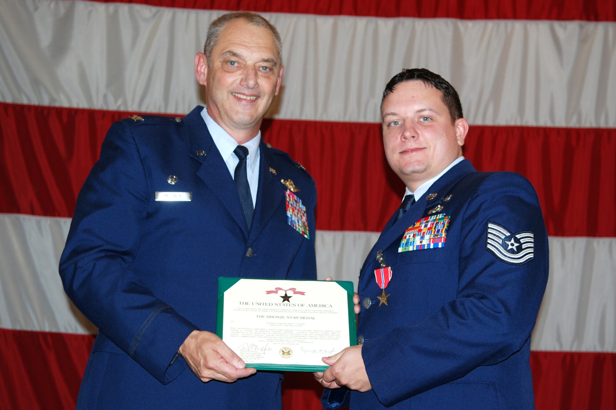 Technical Sgt. Brett Vickers, 917th Explosive Ordnance Disposal (EOD) Flight, poses for a photo with Col. John J. Mooney III, commander of the 917th Wing after being presented The Bronze Star Medal during award ceremonies in Hoban Hall at Barksdale Air Force Base, La., Sept. 12, 2010. Sergeant Vickers was awarded the medal for service while deployed to the 755th Bravo EOD Flight in Afghanistan from Sept. 30, 2009 to March 31, 2010. (U.S. Air Force photo/Master Sgt. Greg Steele)