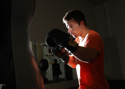 Senior Airman Todd Tetreault hits a punching bag during the Boxing and Muay Thai class at the Chaparral boxing training room. (U.S. Air Force photo/Robbin Cresswell)