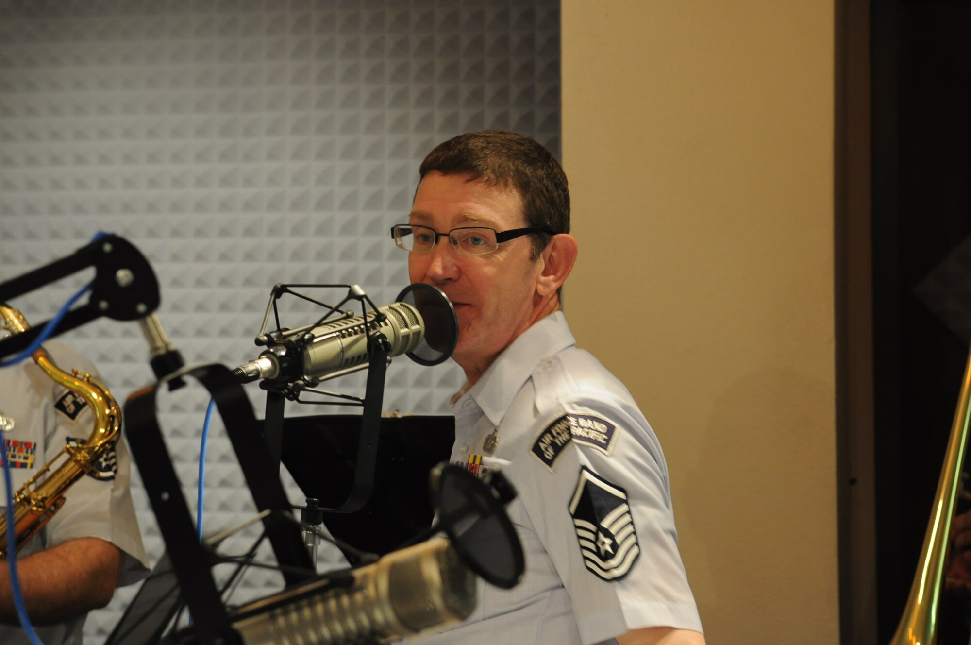 MSgt George Pierce, trumpeter with the USAF Band of the Pacific, answers a question about the band during a recent radio interview.  The Band of the Pacific's 'Dixie Express' were featured on KUAC radio's broadcast "Alaska Live", a program which features live in-studio performances of musicians touring in Alaska. (U.S. Air Force photo/Lisa Scerbak)
