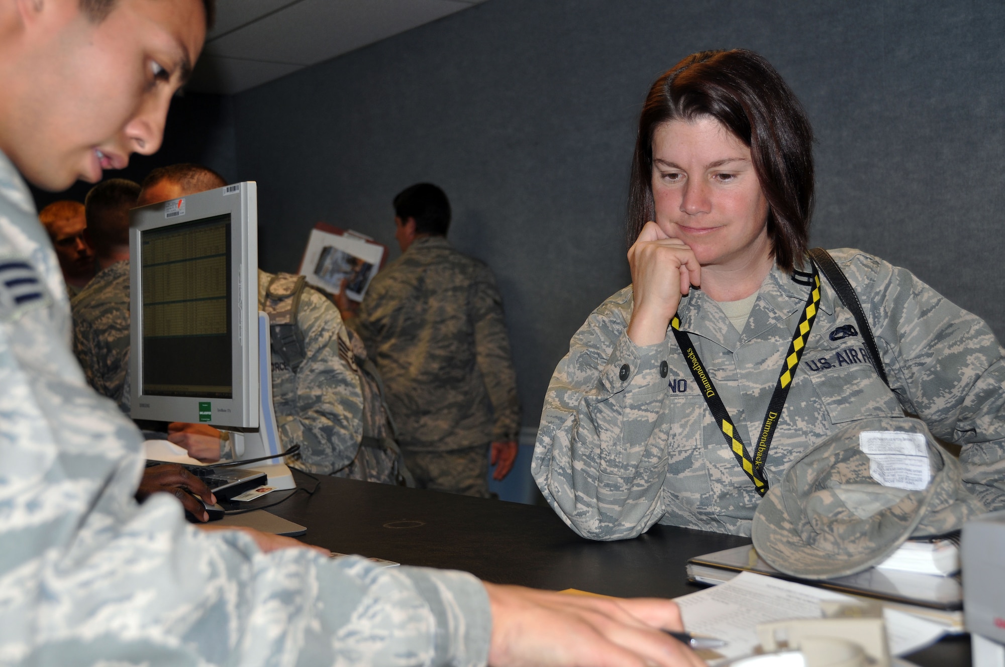 HILL AIR FORCE BASE, UTAH -- Senior Airman Dinno Lorenzo, 75th Aerospace Medicine Squadron, reviews immunization records for Capt. Nancy Immormino, 419th Maintenance Squadron, as she prepares to deploy to Afghanistan. Captain Immormino and about 40 other reserve Airmen from the 419th MXS and 419th Aircraft Maintenance Squadron deployed this week alongside active duty personnel from the 388th Fighter Wing for tours that range from 90 days to 180 days. (U.S. Air Force photo/Bryan Magaña)