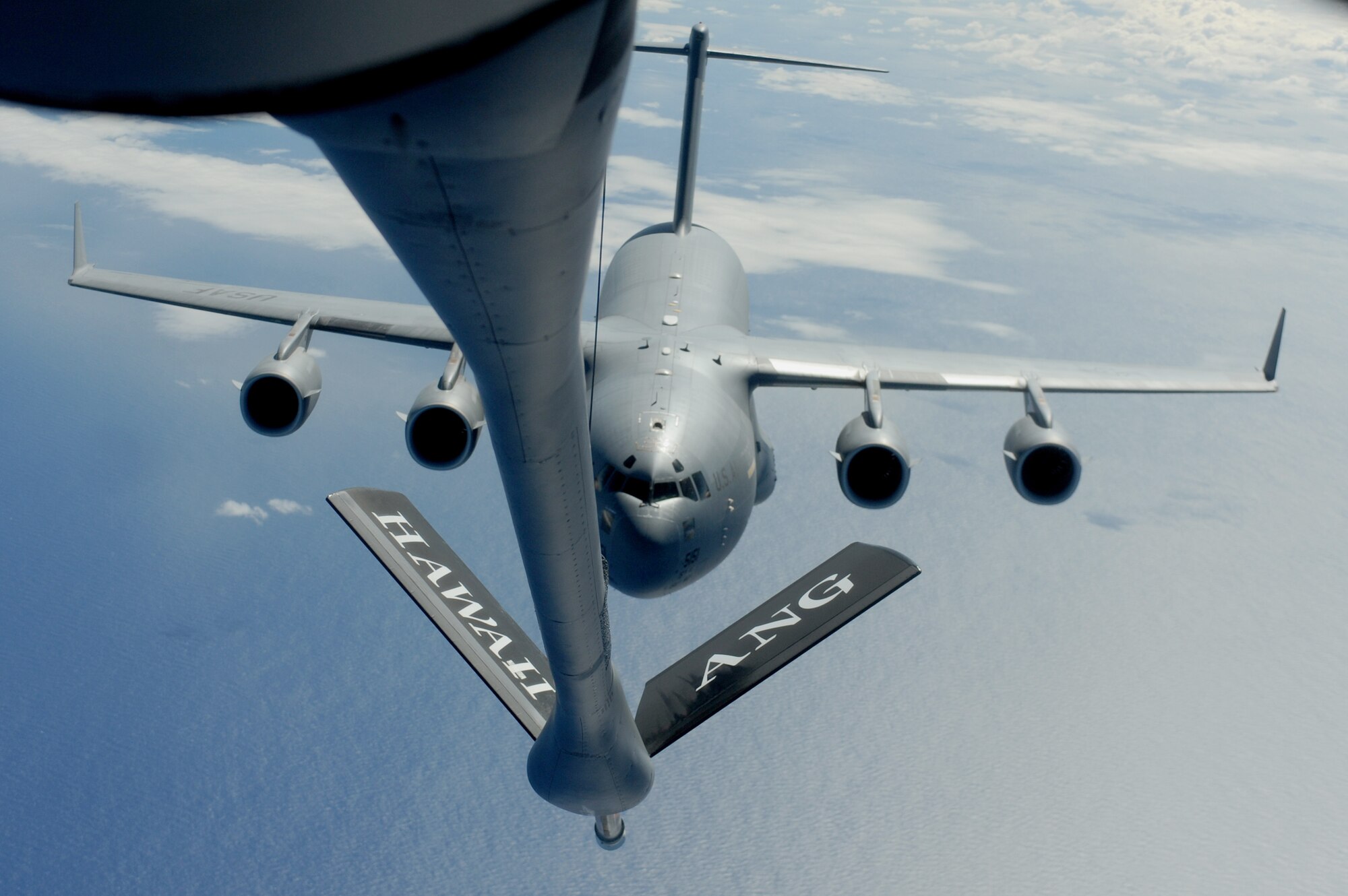 A KC-135 Stratotanker lowers the boom for a C-17 Globemaster III Sept. 18, 2010, over the Pacific Ocean during a Total Force partnership mission. The C-17 is assigned to the 15th Wing at Joint Base Pearl Harbor-Hickam, Hawaii, and the KC-135 is from a Hawaii Air National Guard's 204th Air Refueling Squadron. (U.S. Air Force photo/Staff Sgt. Mike Meares)