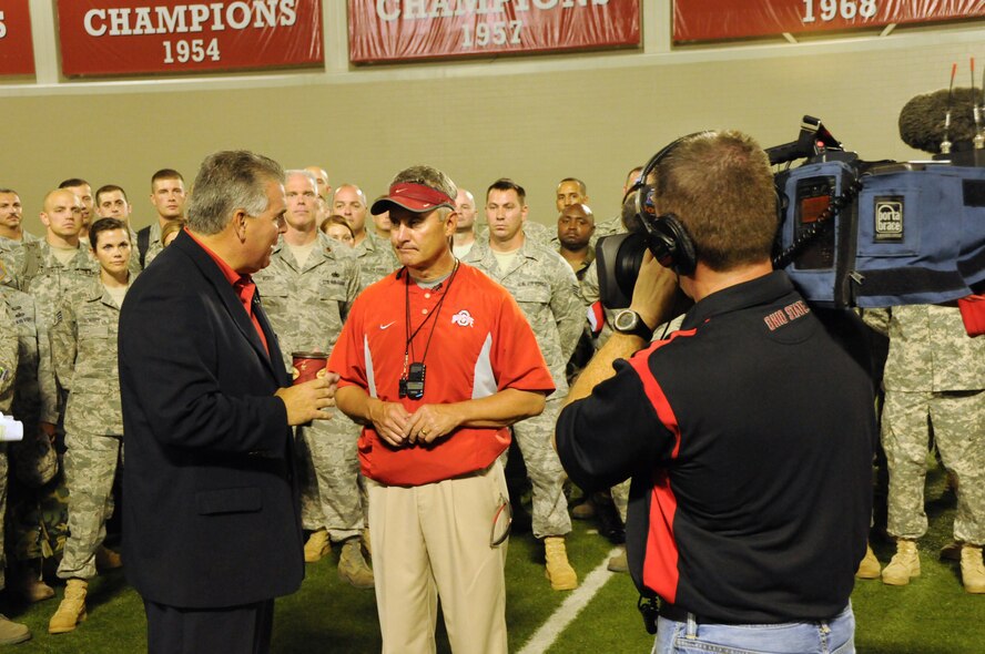 Ohio State University football coach Jim Tressel speaks with the media after practice while members of the Ohio Air and Army National Guard look on Sept. 22, 2010.
Over 100 Servicemembers were invited to attend a meet and greet with the Ohio State University football team.