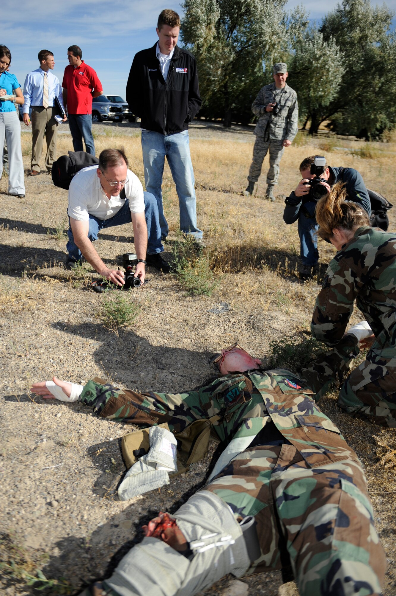 MOUNTAIN HOME AIR FORCE BASE, Idaho -- Media from the surrounding area captures footage of the 366th Medial Group performing self aid and buddy care during an exercise for media day Sept. 17. The goal of media day was to strengthen relationships with local media agencies and give access to the Airmen and mission of the base. (U.S. Air Force photo by Senior Airman Renishia Richardson)