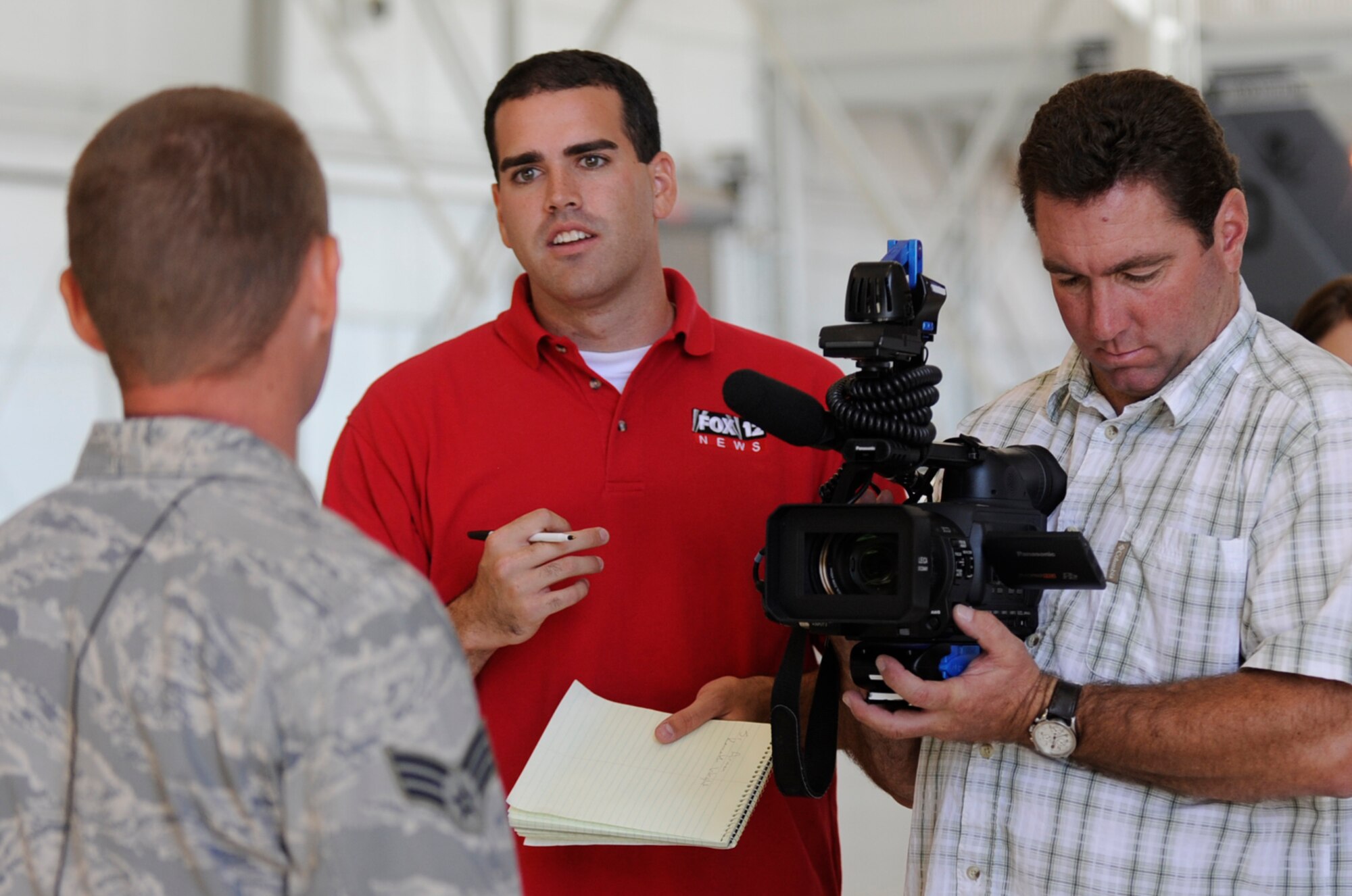 MOUNTAIN HOME AIR FORCE BASE, Idaho -- Matthew Loveless, KTRV Fox 12 Television reporter and colleague Jeffery Gordon, KTRV Fox 12 Television photojournalist, interview Senior Airman Kenneth Wright, 391st Fighter Squadron crew chief, during media day Sept. 17. The goal of media day was to strengthen relationships with local media agencies and give access to the Airmen and mission of the base. (U.S. Air Force photo by Senior Airman Renishia Richardson)