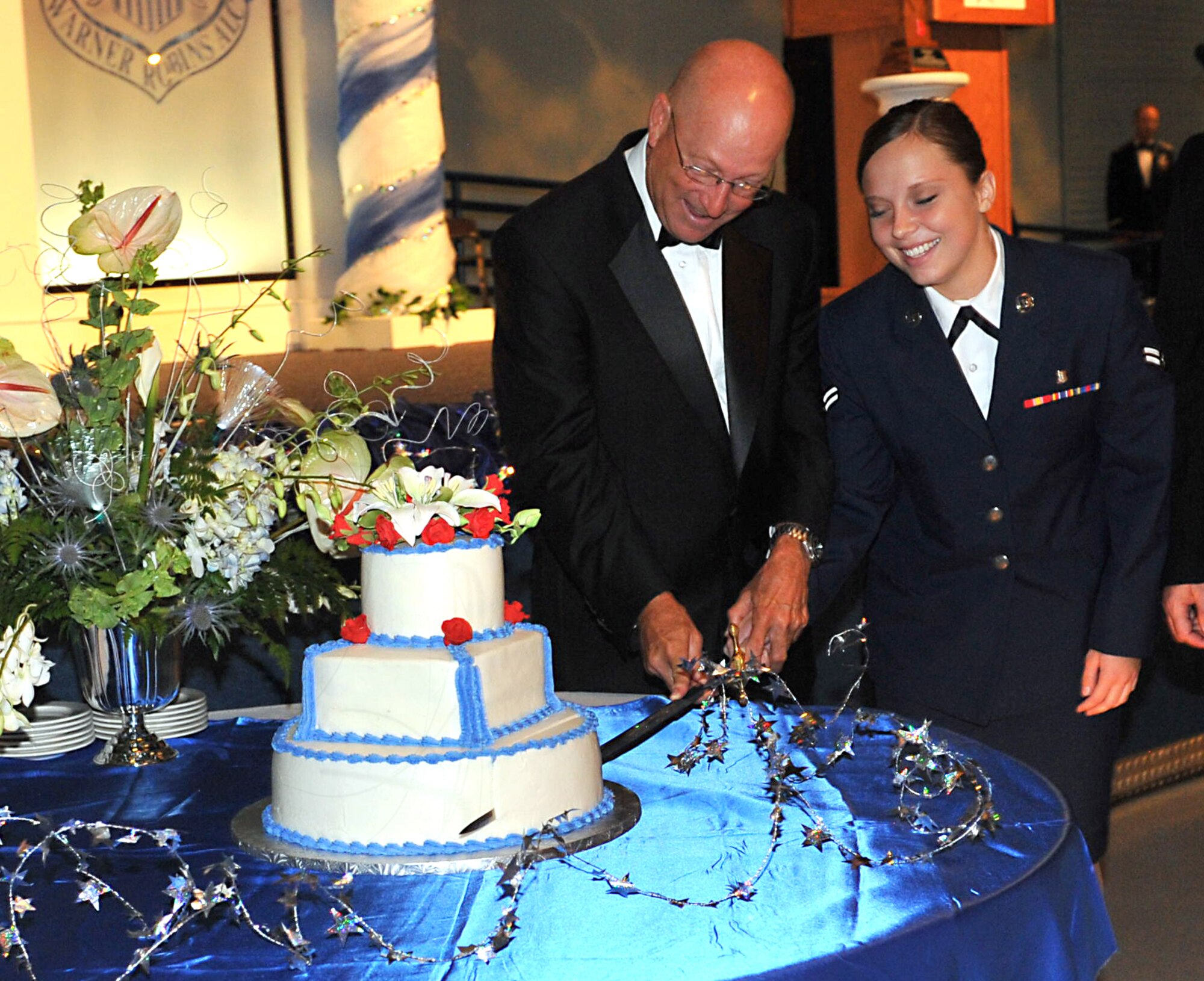 Retired Gen. Victor E. Renuart Jr., former commander of North American Aerospace Defense Command and U.S. Northern Command and Airman 1st Class Niccolet Ghio, 78th Medical Operations Squadron, cut the  cake during Robins 63rd AirForce birthday celebration. The event included a black tie/mess dress dinner at the Museum of Aviation with music by the Air Force Reserve Band and a keynote address by Renuart. U. S. Air Force photo by Tommie Horton